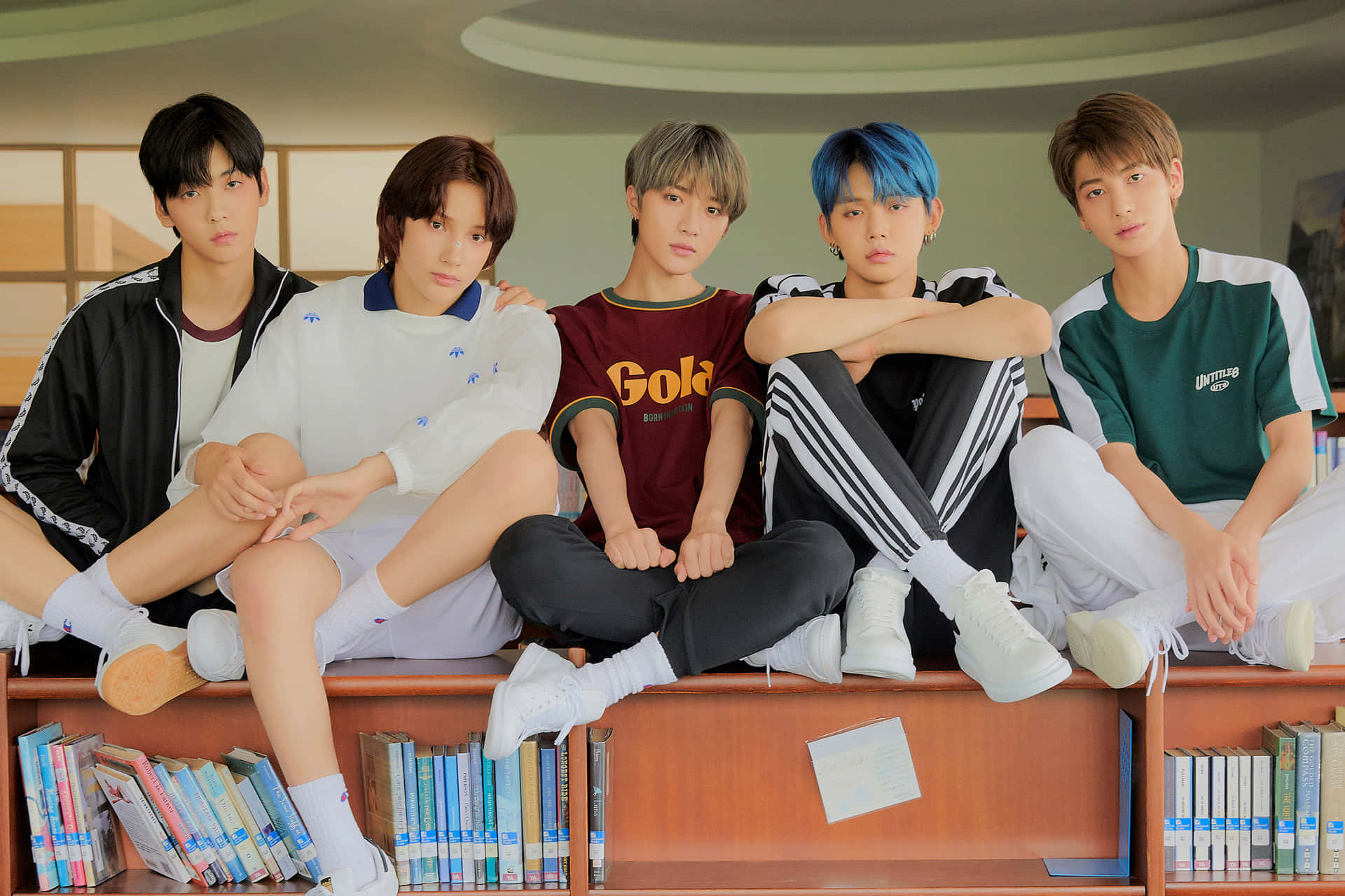 A Group Of Boys Sitting On A Shelf Wallpaper