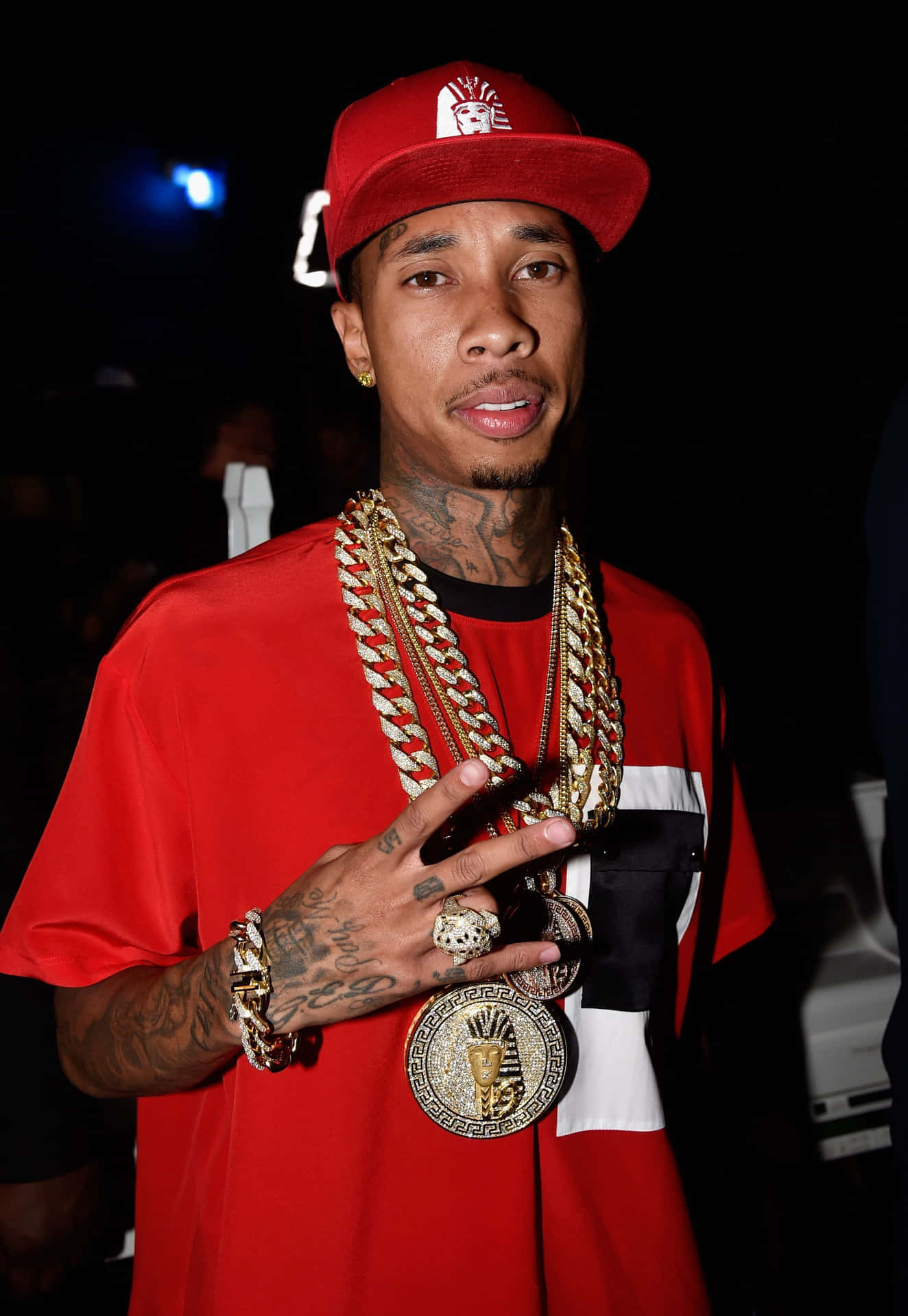 Download Tyga Flexing His Muscles On The Beach Wallpaper | Wallpapers.com