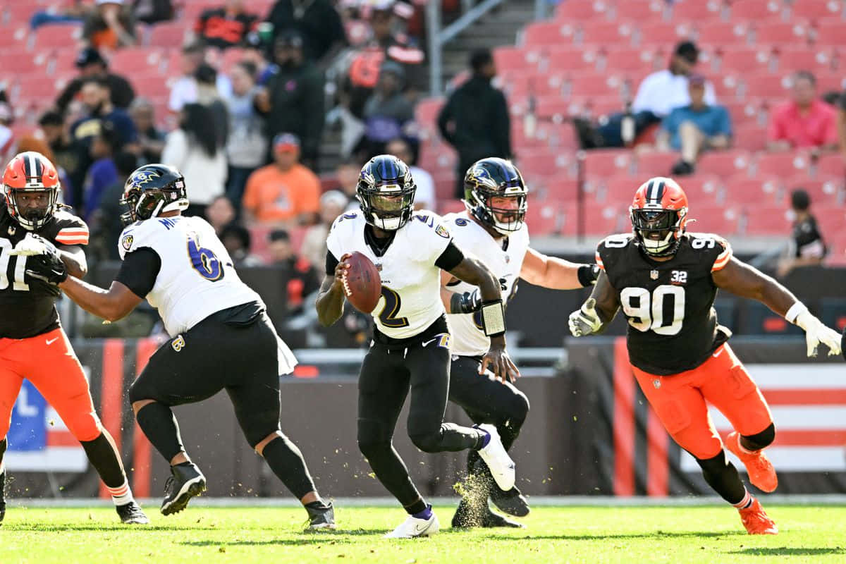 Tyler Huntley Evading Defenders During N F L Game Wallpaper