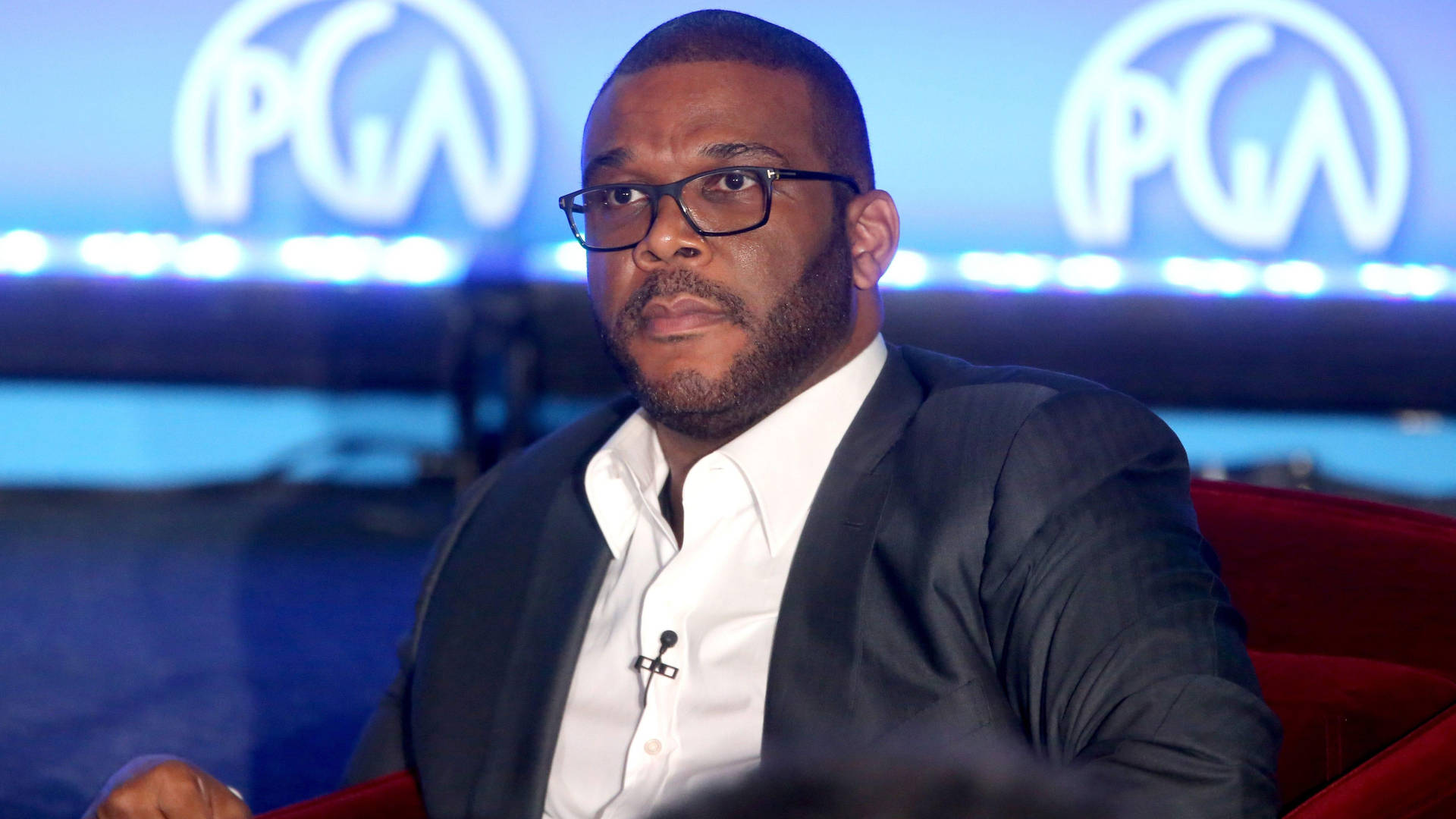 Caption: Award-winning film director Tyler Perry in a classic suit Wallpaper