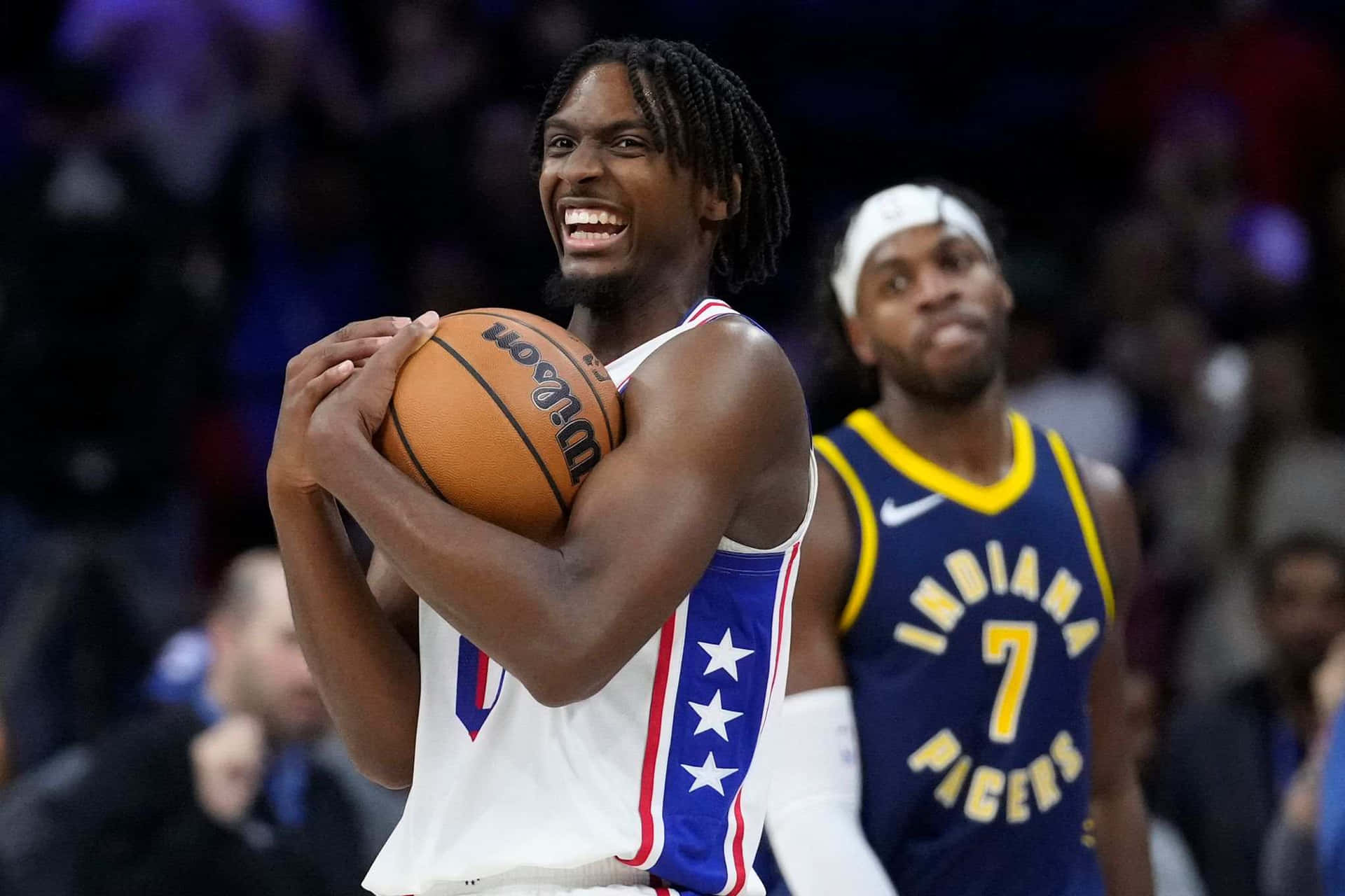 Tyrese Maxey Smilingwith Basketball Wallpaper