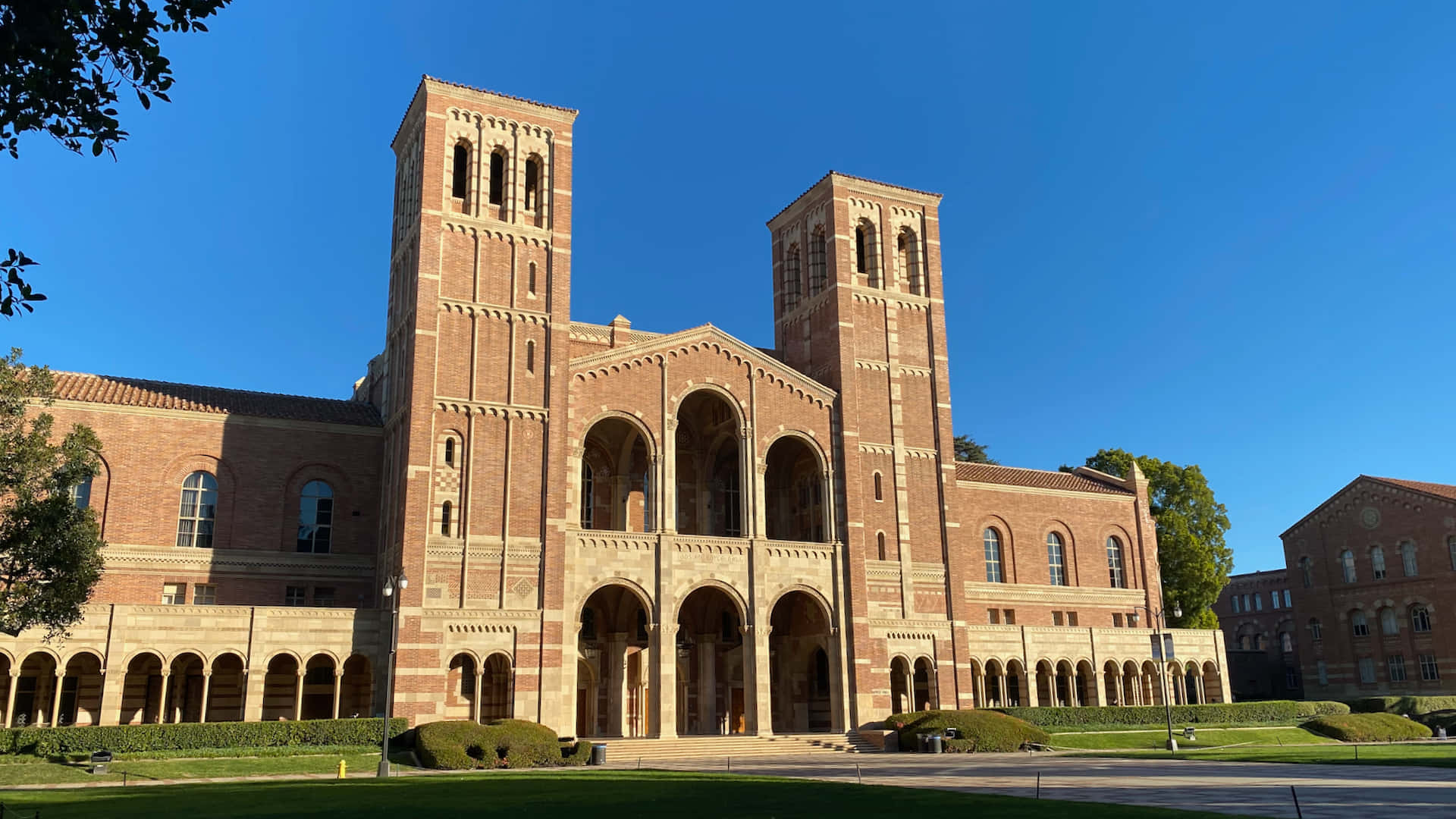 A Large Brick Building With A Large Lawn Wallpaper
