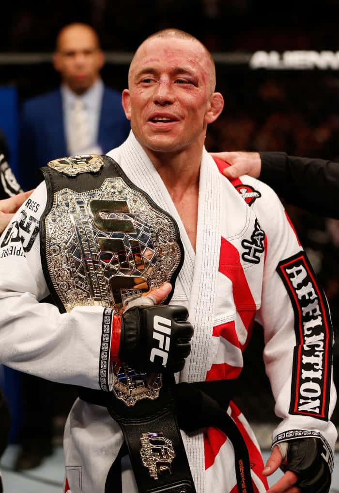 Ufc Fighter Georges St-pierre With Championship Belt Wallpaper