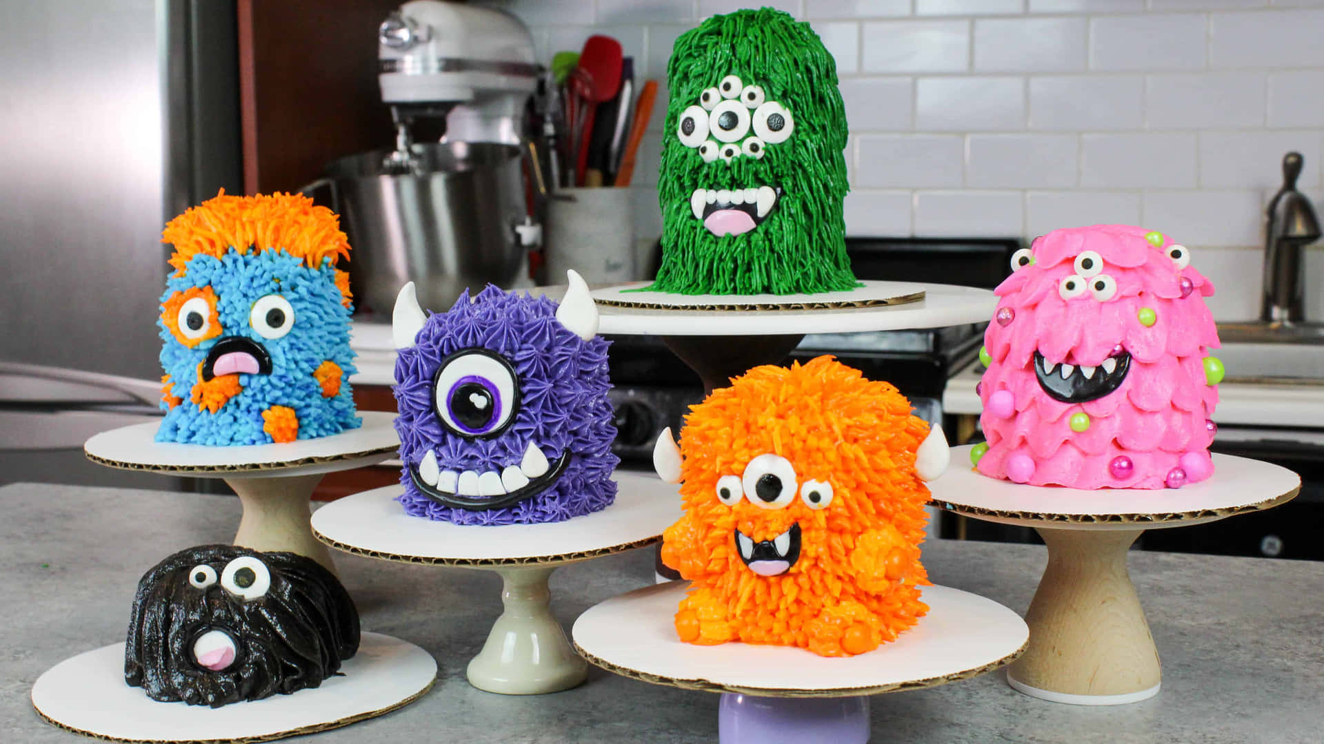 A Group Of Cakes With Monster Faces On Them