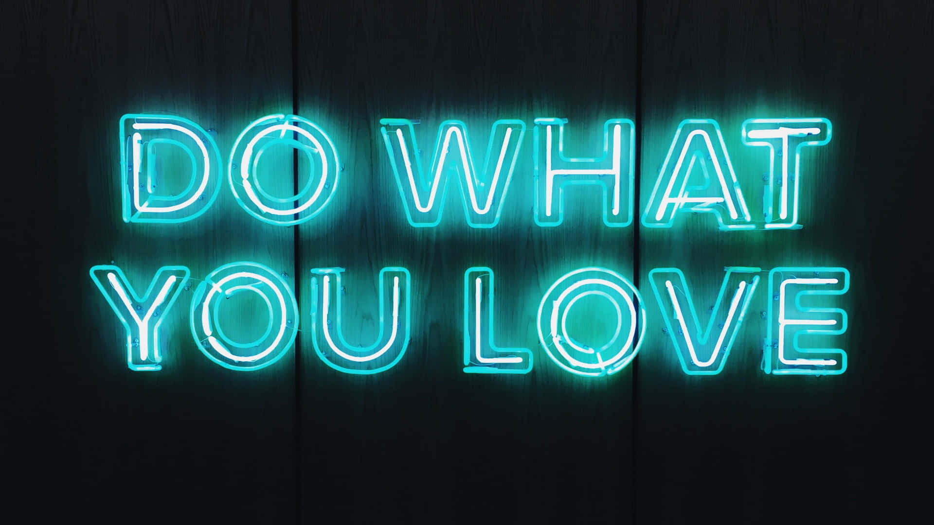Do What You Love Neon Sign On Wooden Background