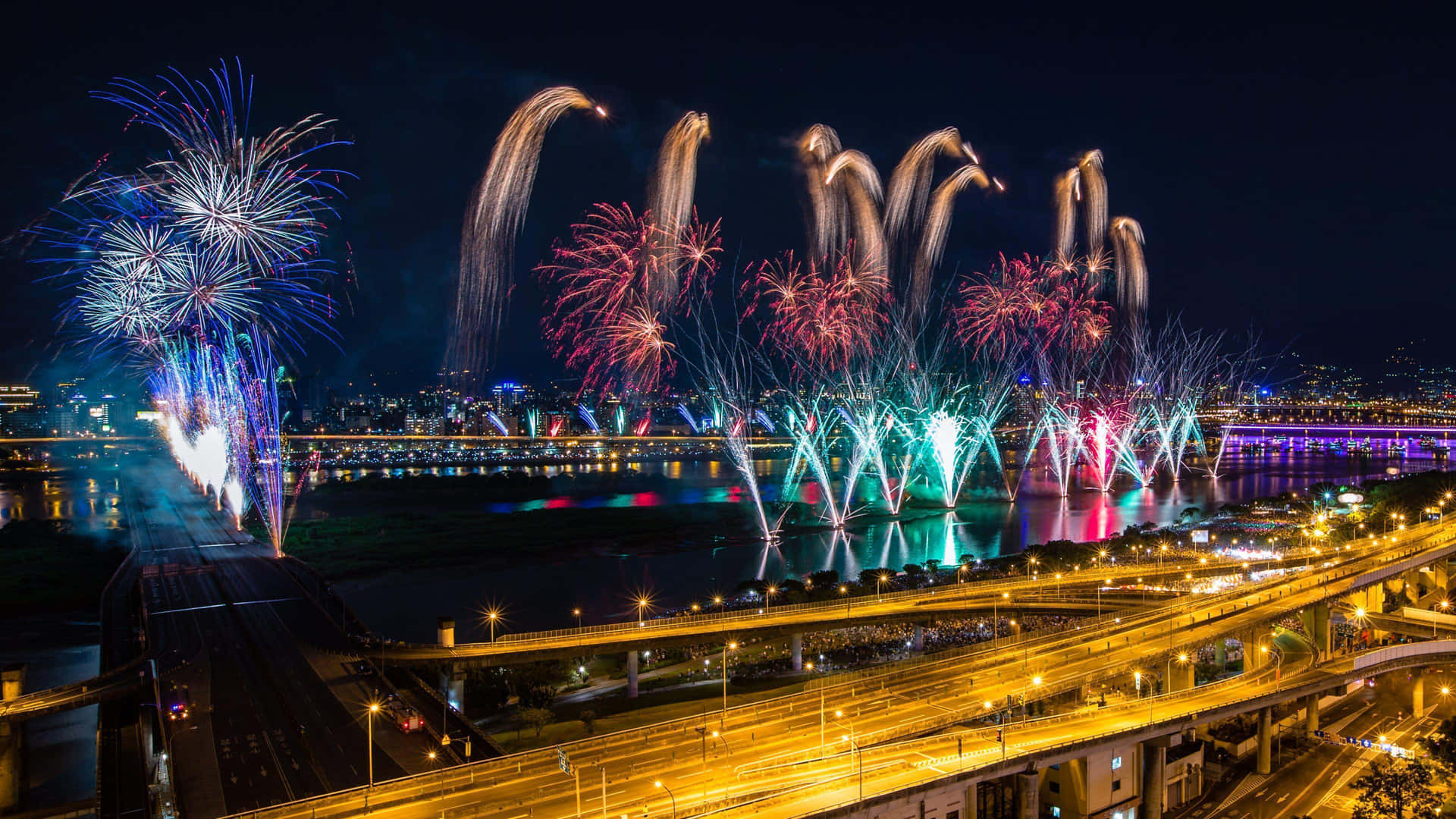Fireworks Are Being Lit Up Over A Bridge