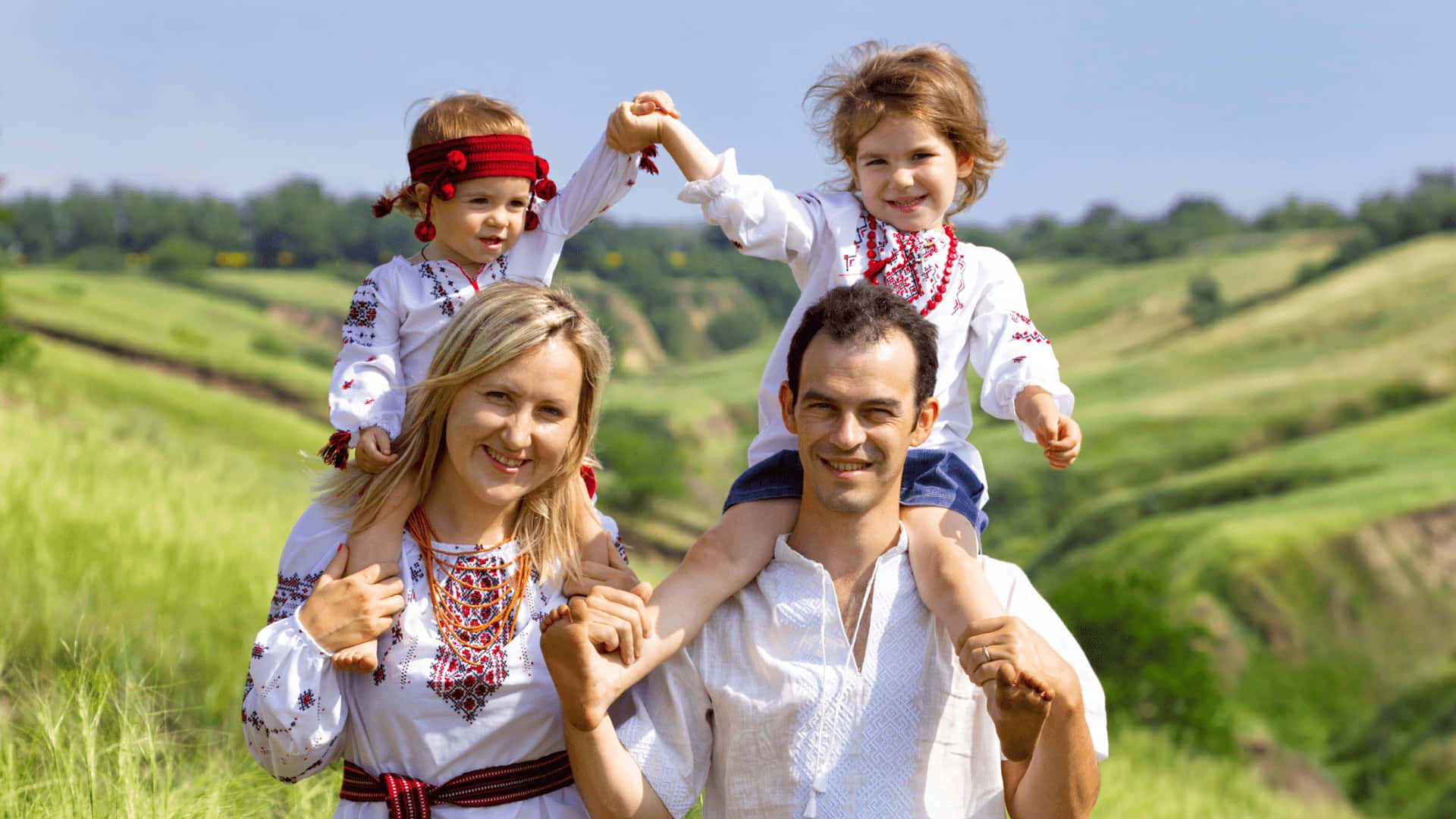A Family In Traditional Clothing Is Standing In A Field