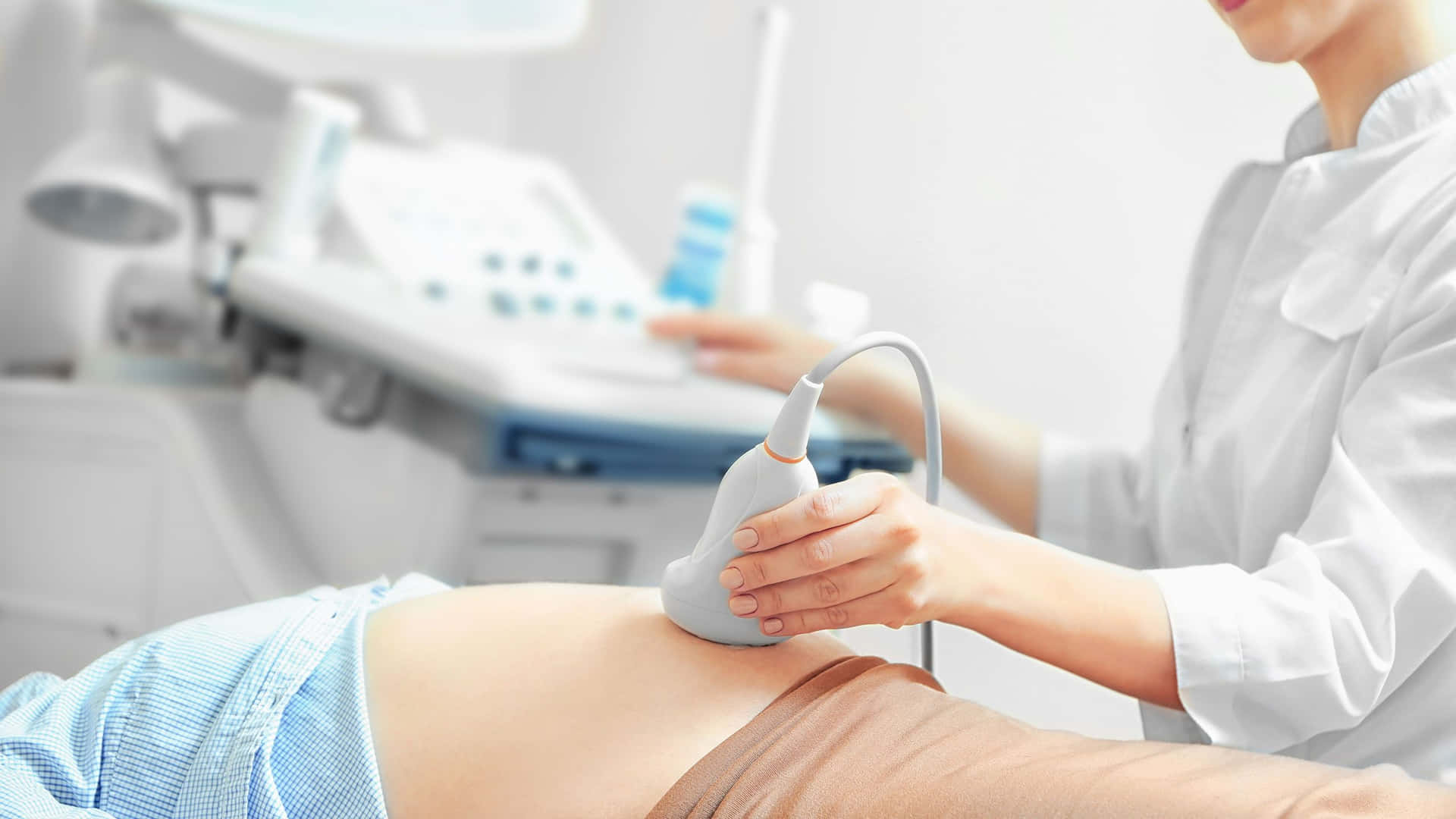 A Woman Is Being Examined By An Ultrasound Machine