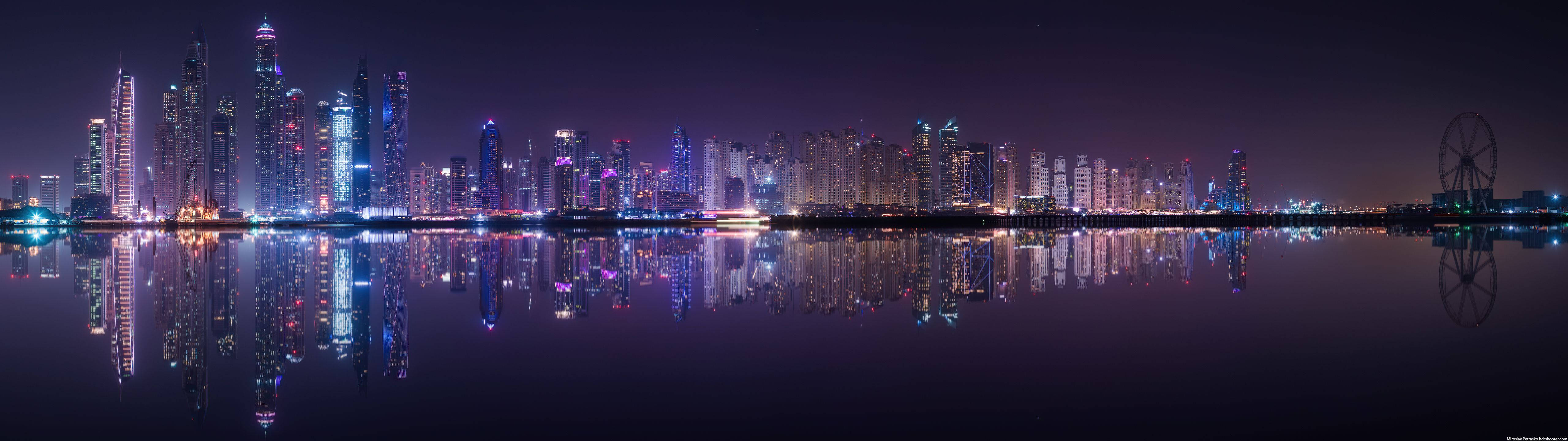 Ultrawide reflection of city lights and tall buildings.