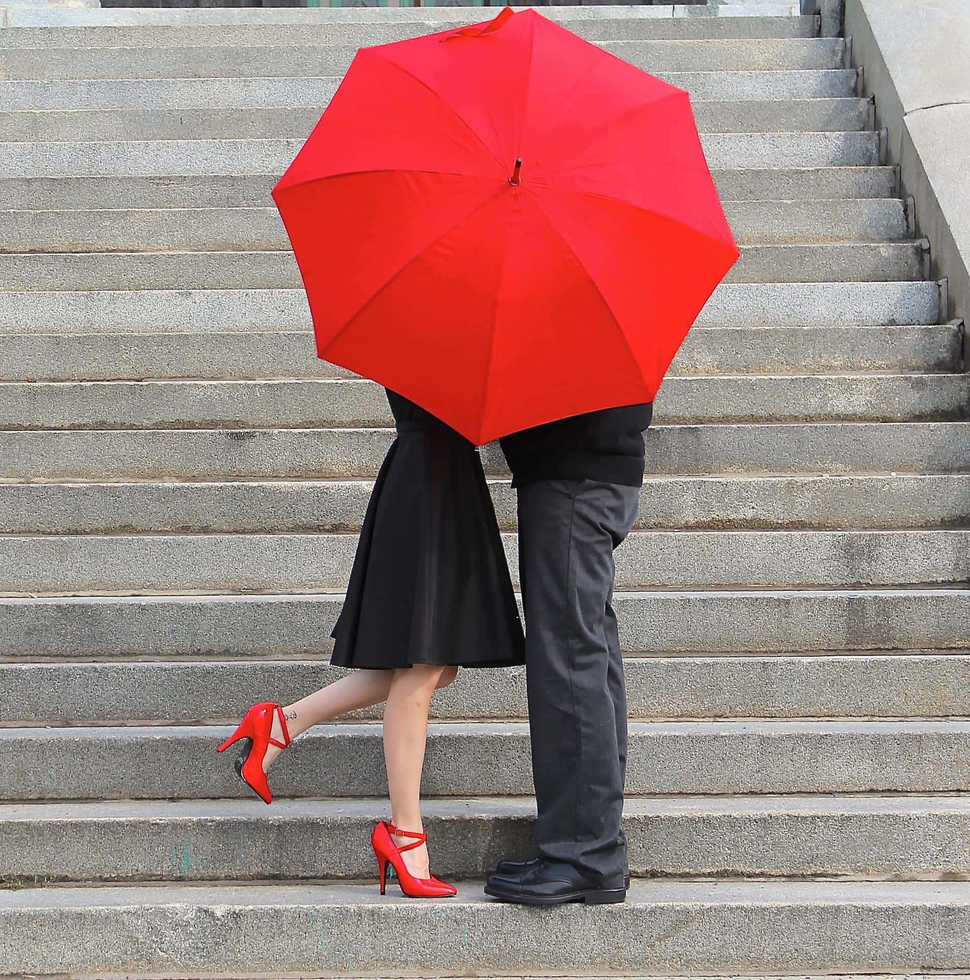 a couple holding an umbrella