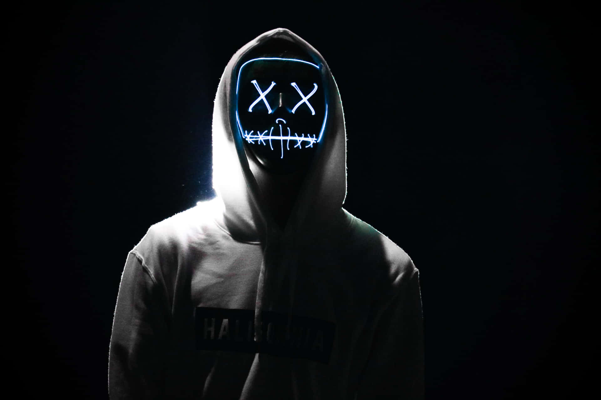 A Person Wearing A White Hoodie With A Neon Mask
