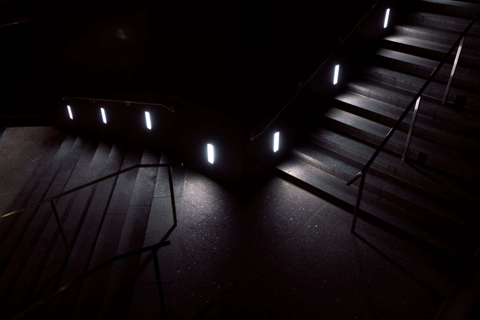 A Dark Staircase With Lights On It