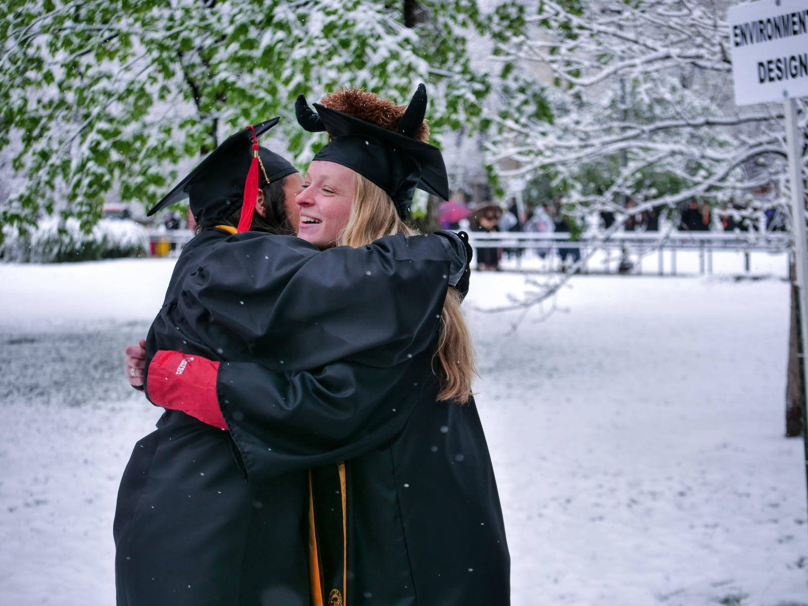 University Of Colorado At Boulder Graduates Hugging Wallpaper