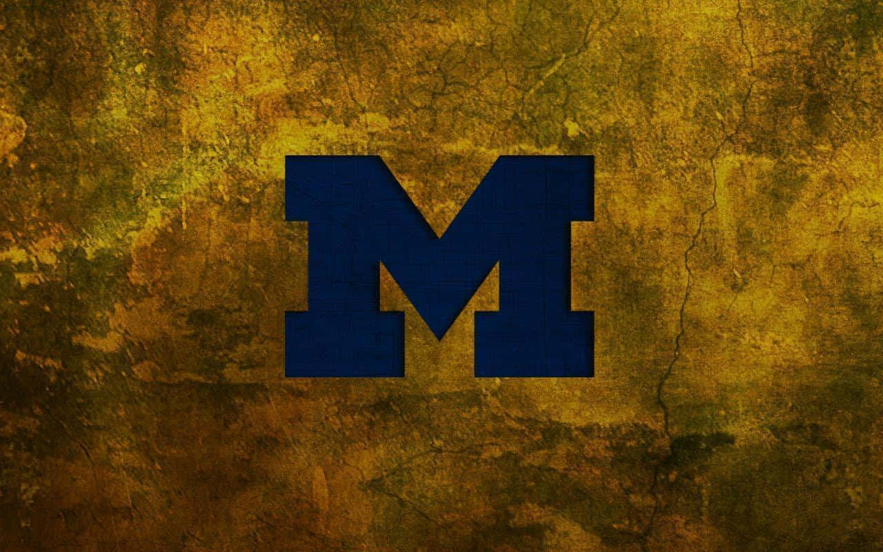 A Blue And Gold Letter M On A Gold Background Wallpaper