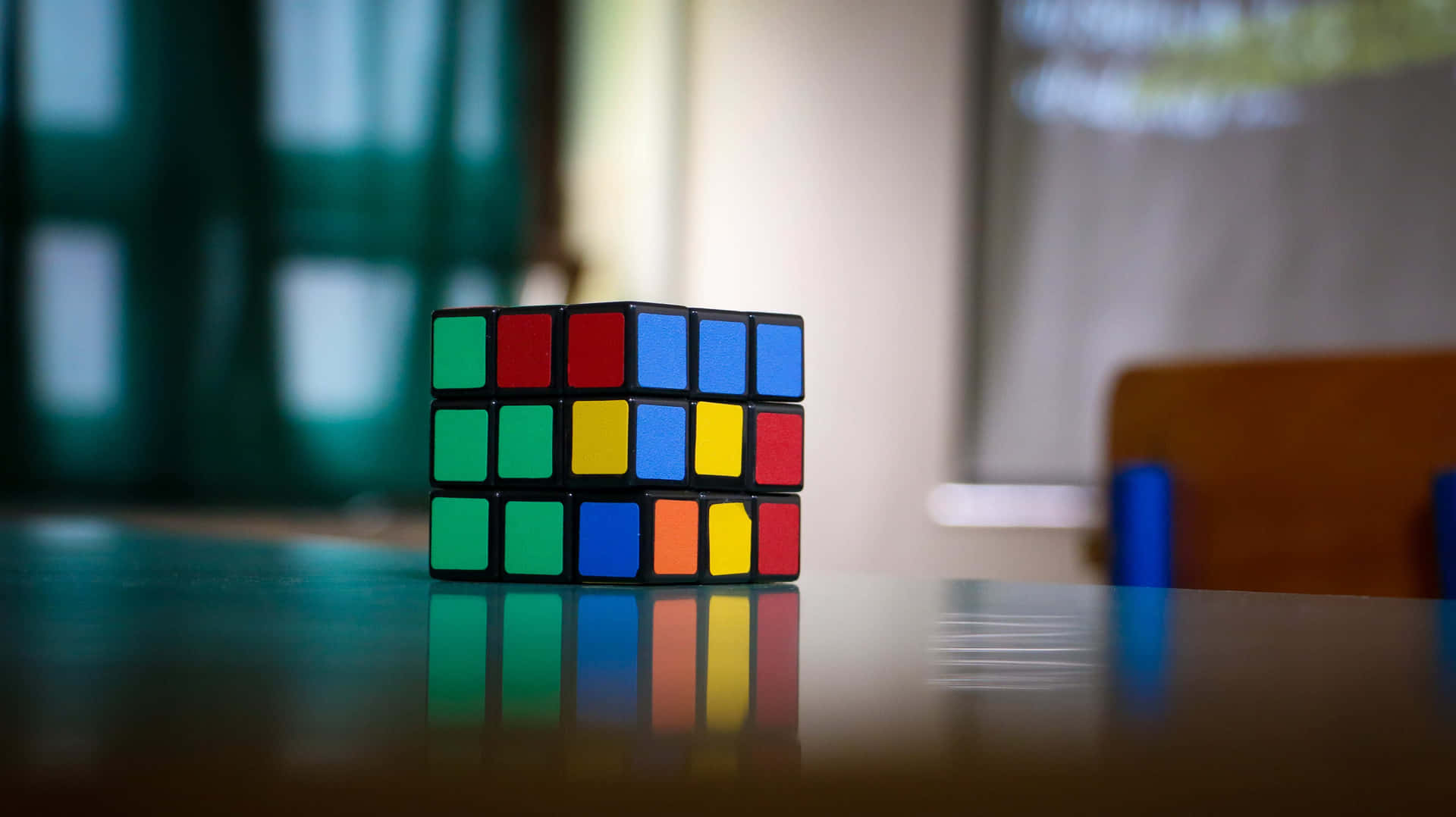 Unsolved Rubiks Cubeon Table Wallpaper