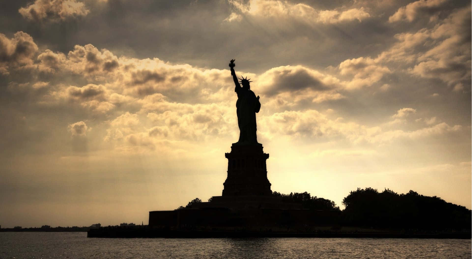 The Statue Of Liberty Is Silhouetted Against The Sky Wallpaper