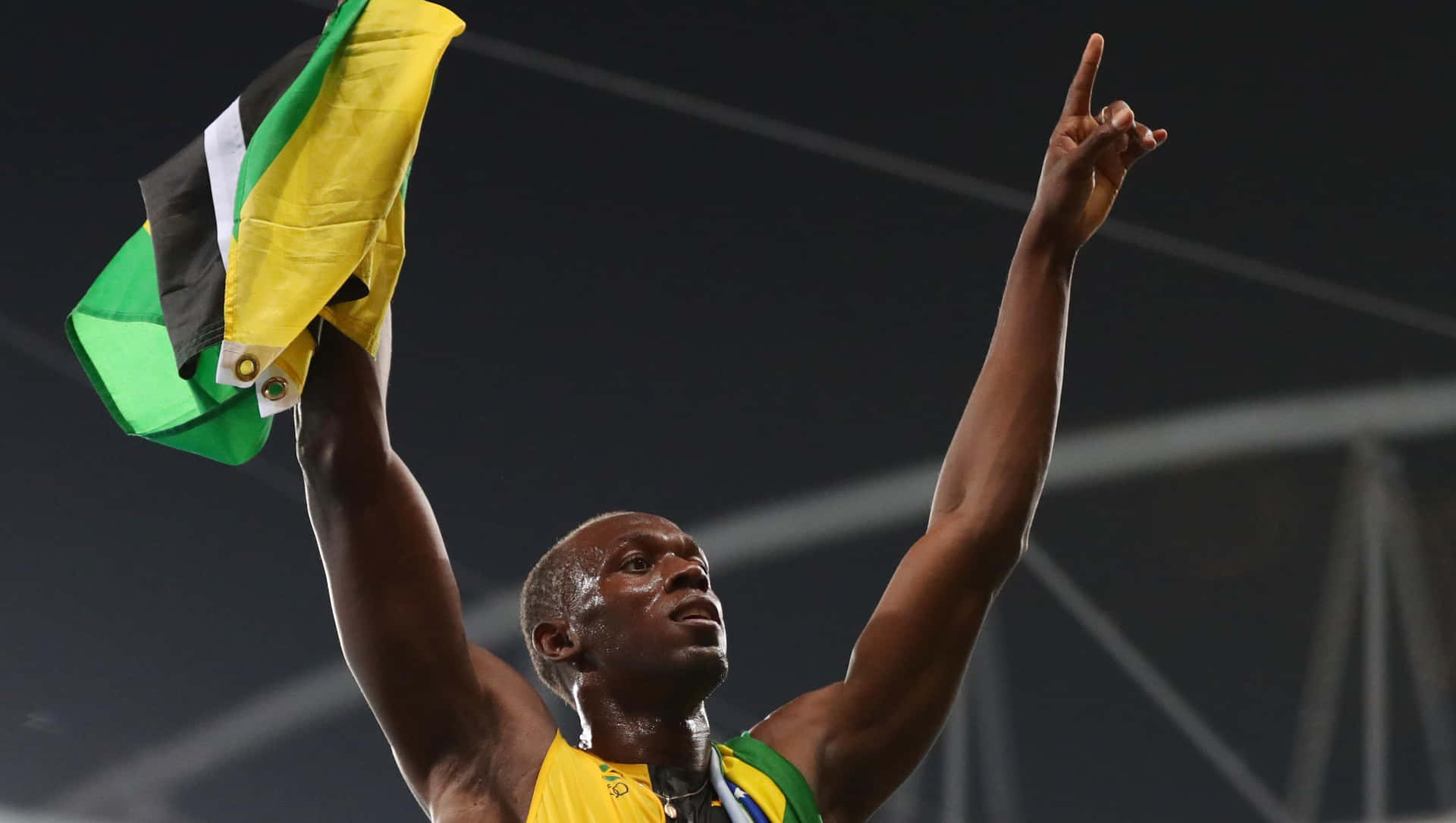 Usain Bolt Triumphantly Cheering with Jamaican Flag Wallpaper