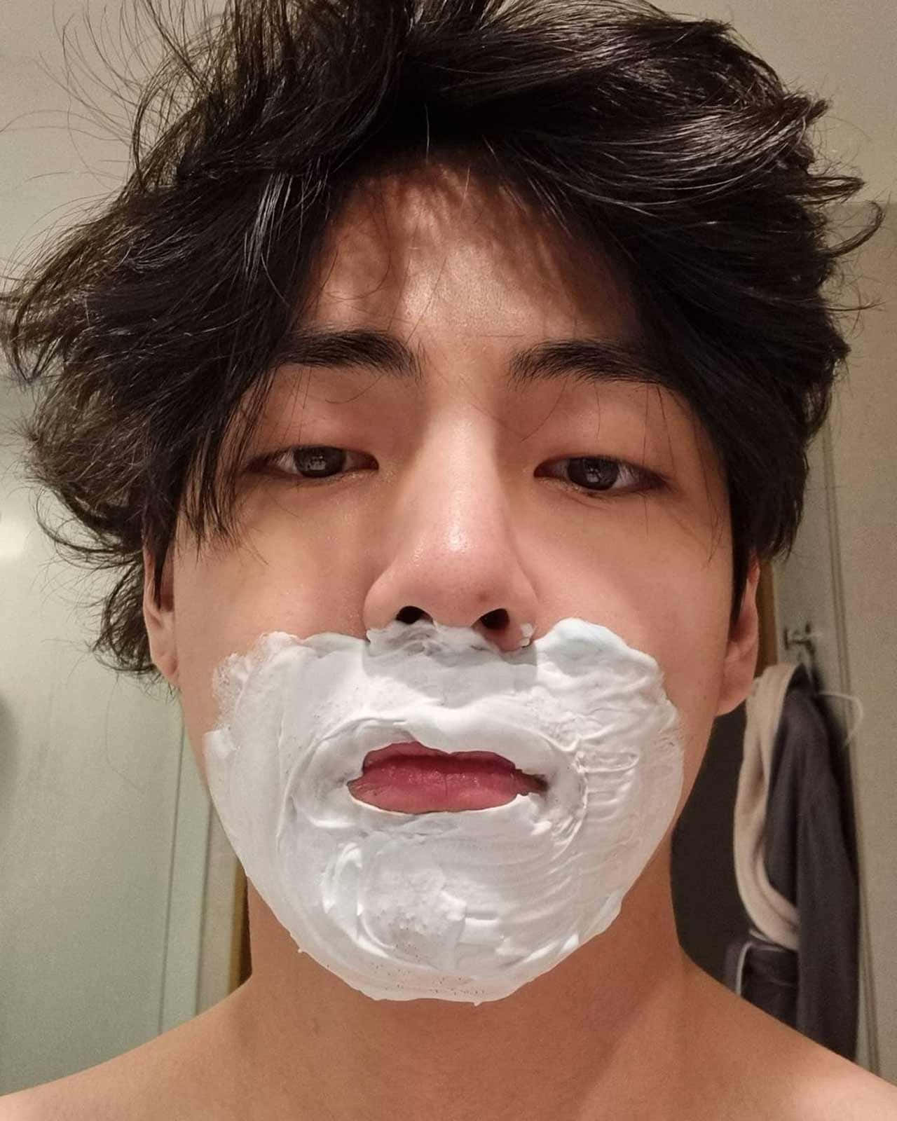 A Man Shaving His Face
