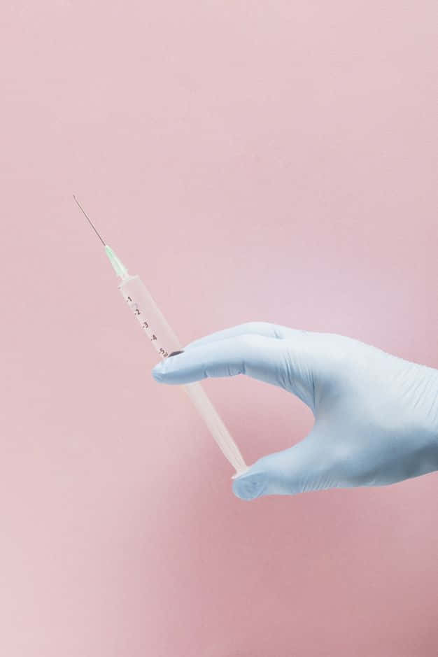 Medical Professional Holding Vaccine Vial and Syringe