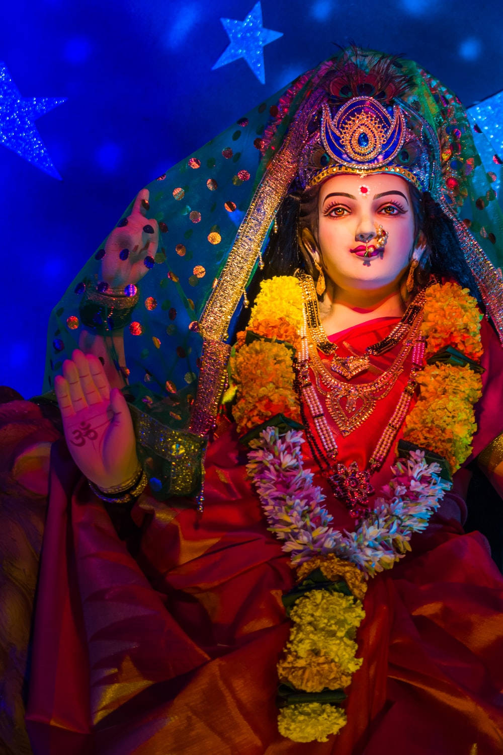 Divine Glow of Vaishno Devi Amidst the Starlit Sky Wallpaper