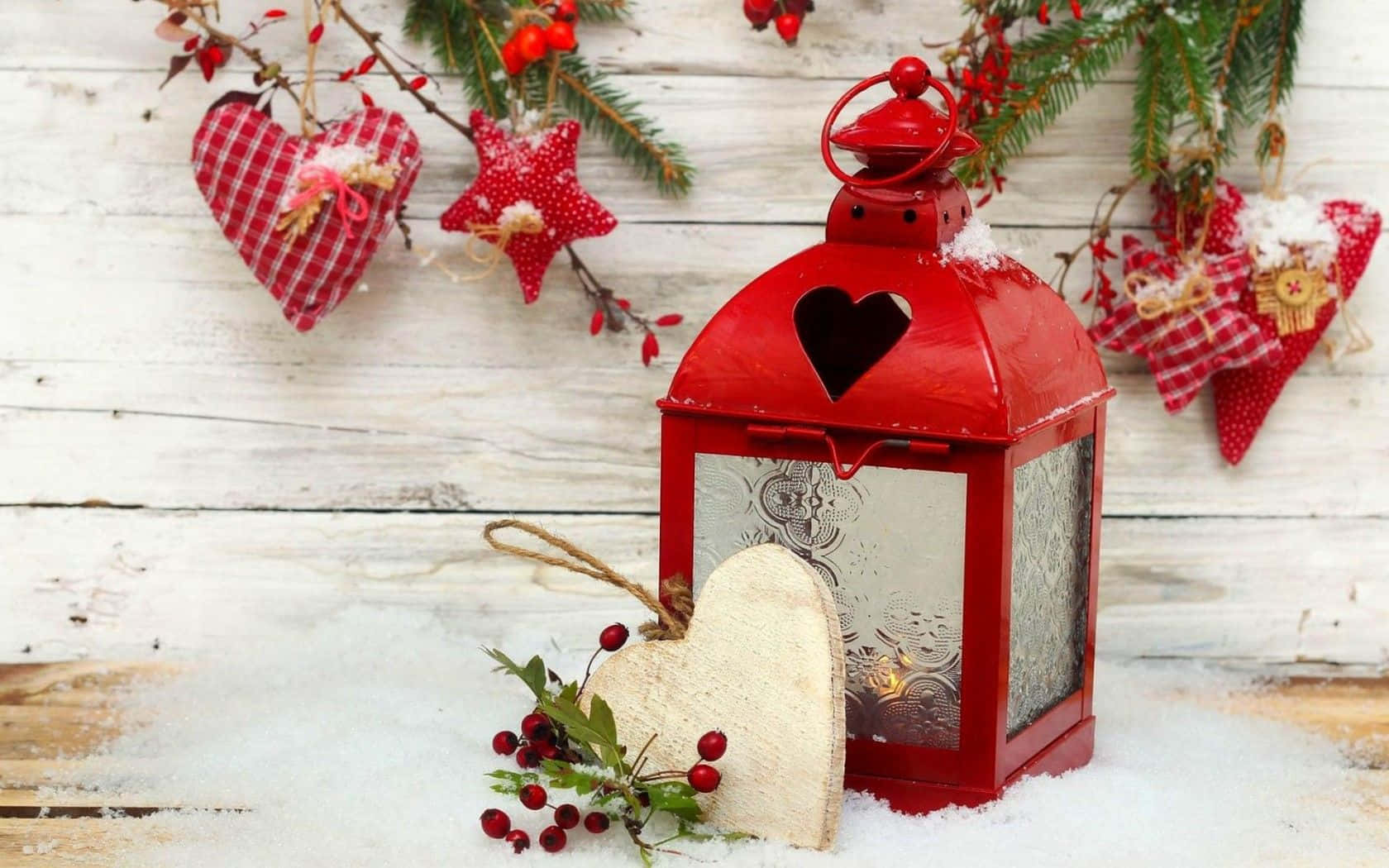 A Red Lantern With A Heart And A Wreath On A Snowy Background
