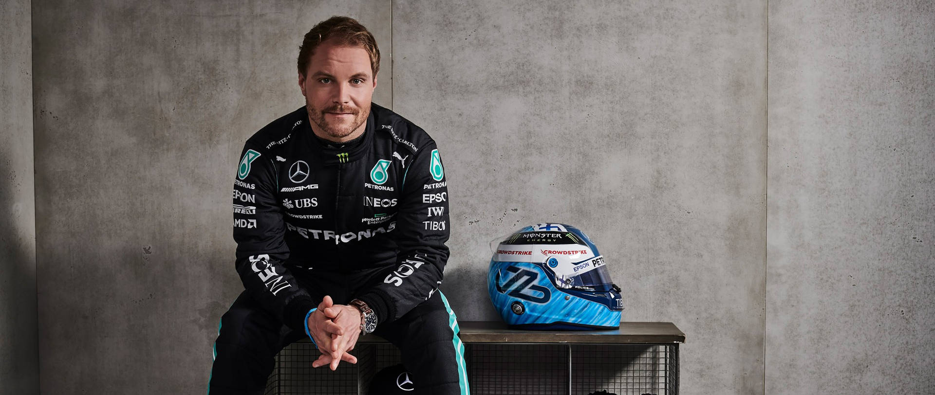Determined Valtteri Bottas sitting with his racing helmet Wallpaper