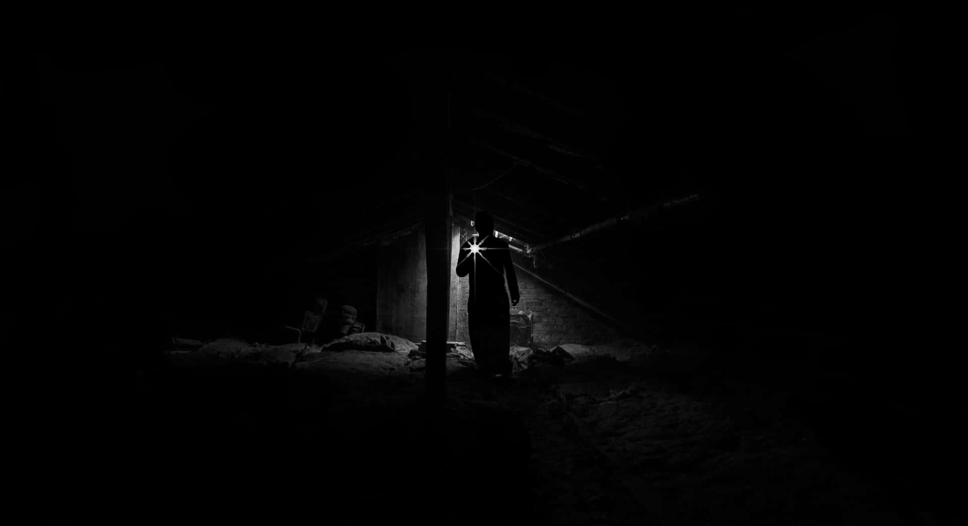 a man standing in the dark in a dark room