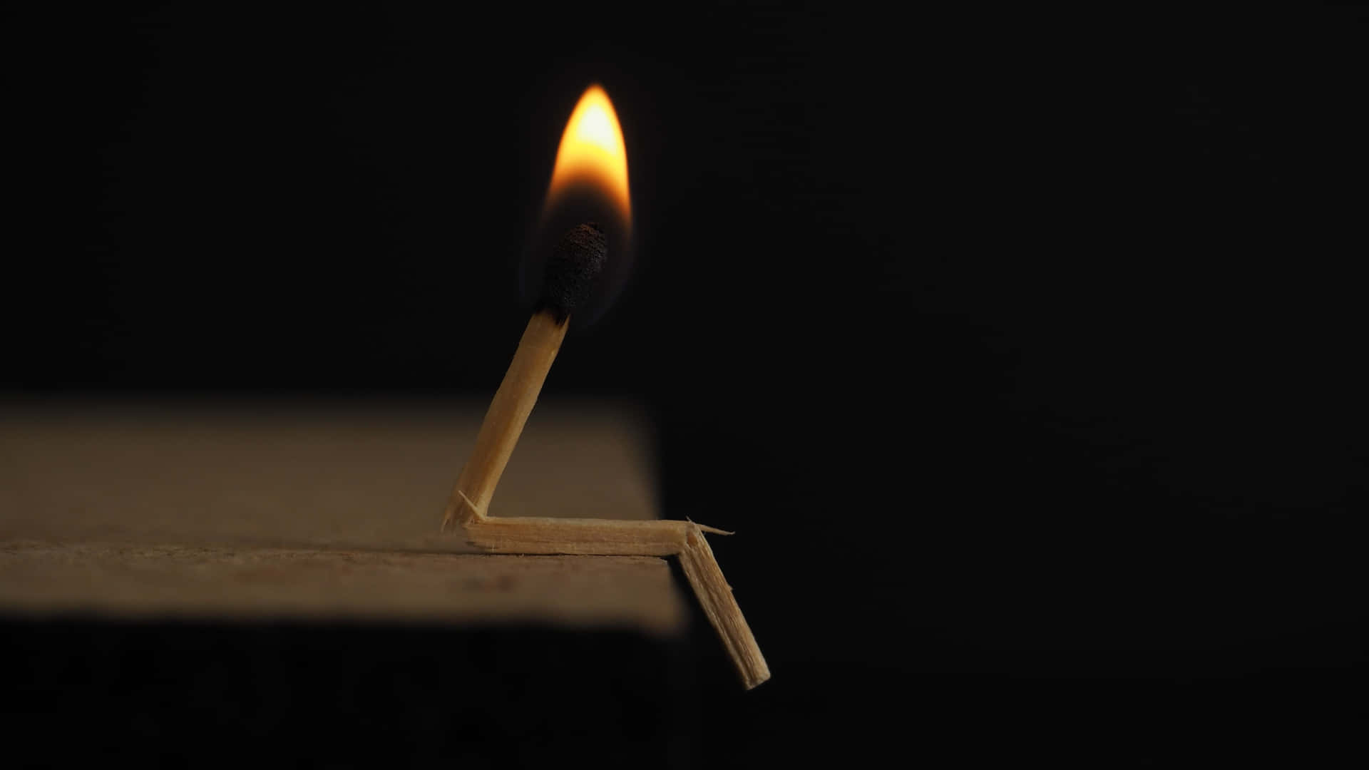 a matchstick is sitting on a wooden table