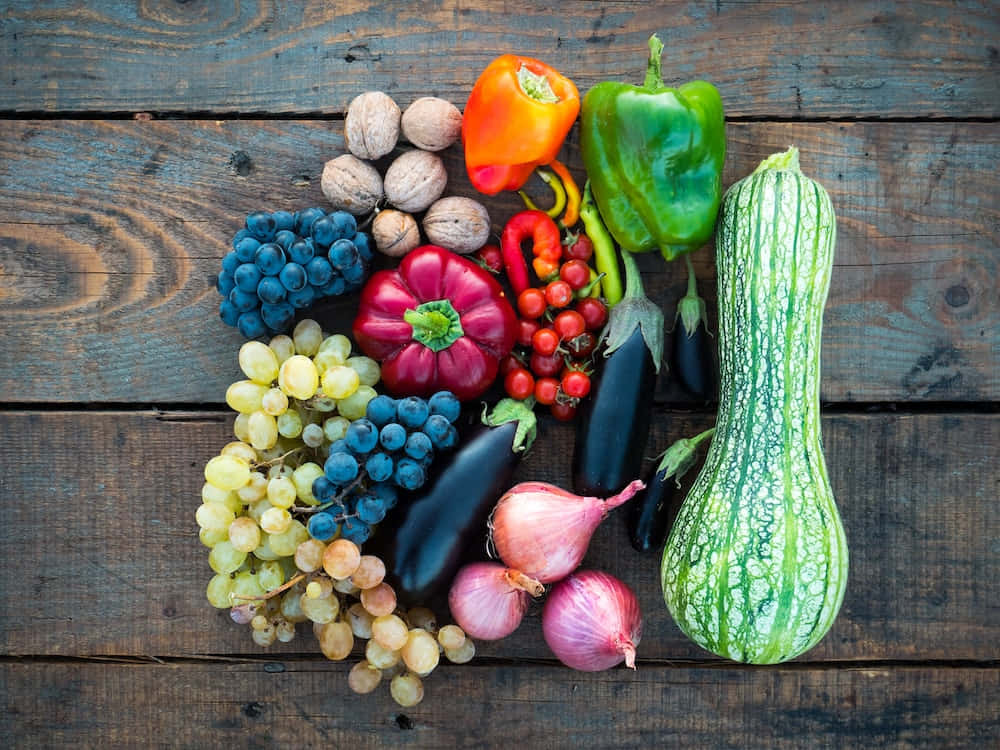 A Variety Of Vegetables And Fruits On A Wooden Table