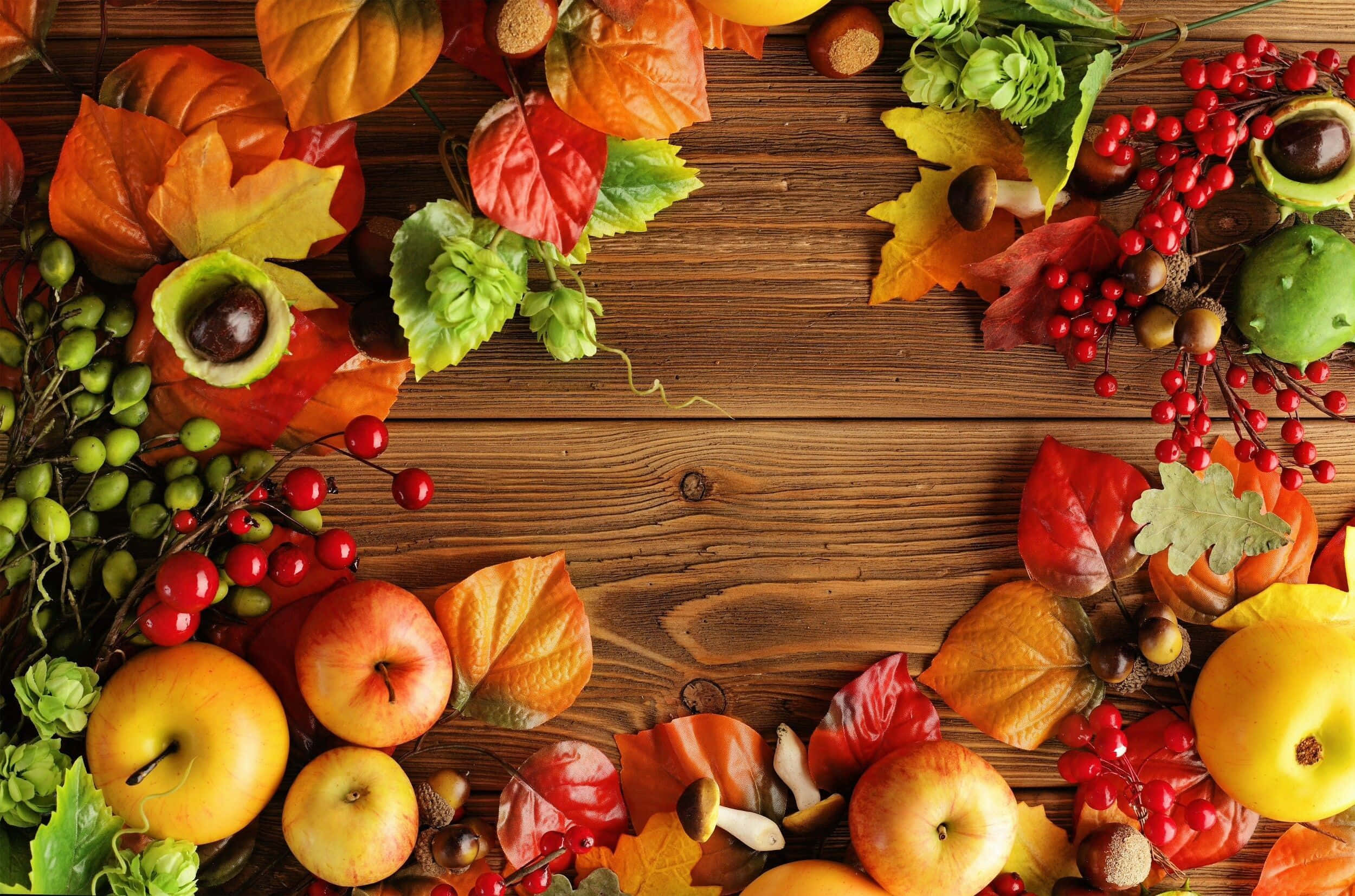 Autumn Leaves And Fruits On A Wooden Table