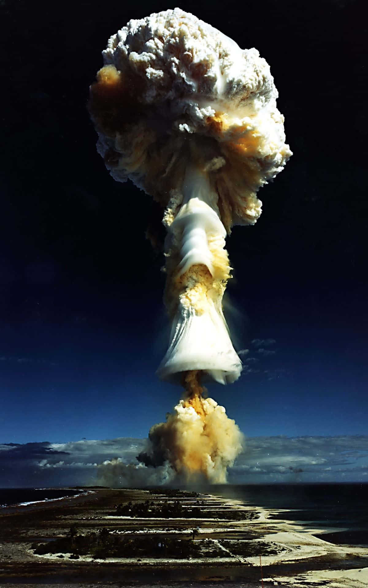A Nuclear Explosion Is Seen Over A Beach Wallpaper