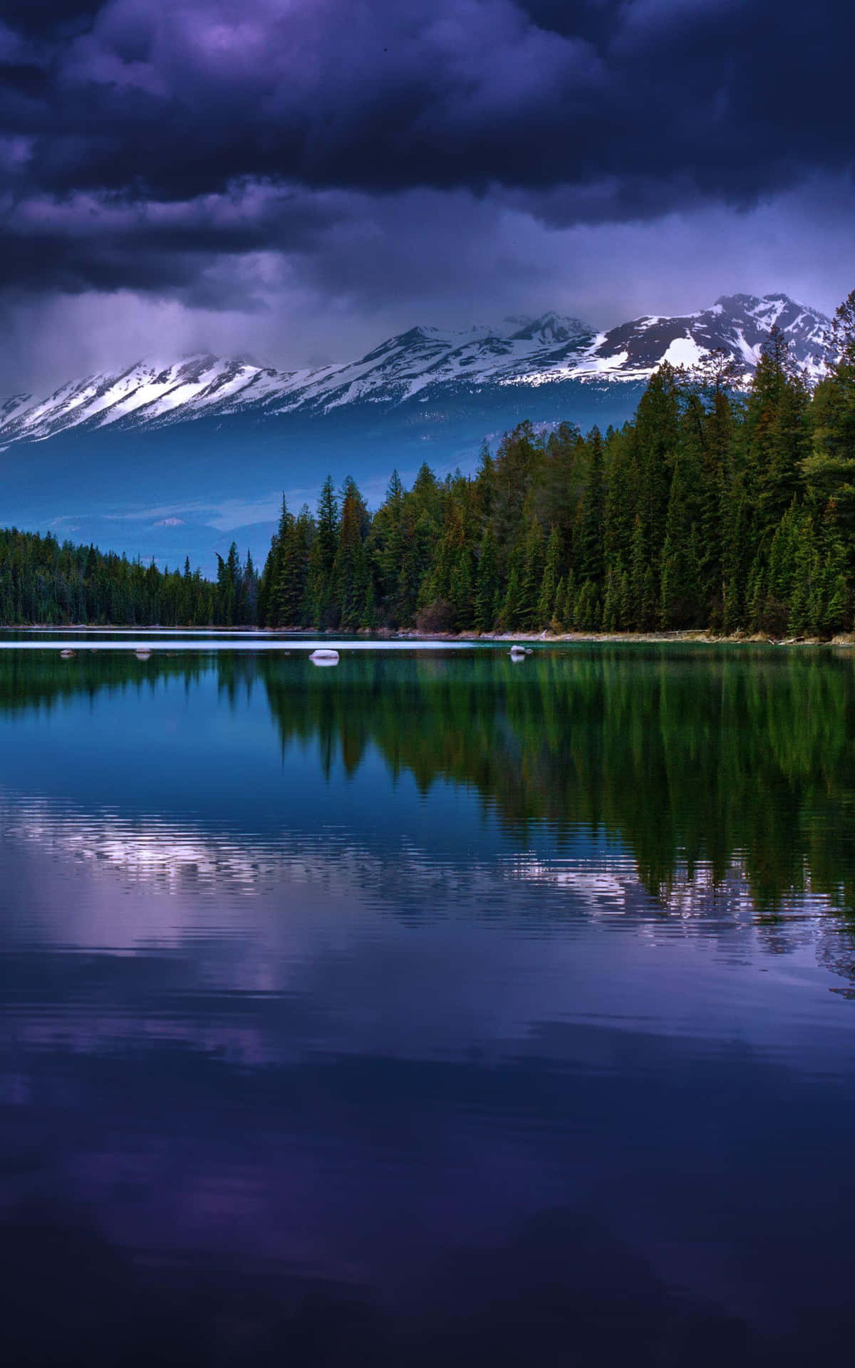 A Lake With Trees And Mountains In The Background Wallpaper