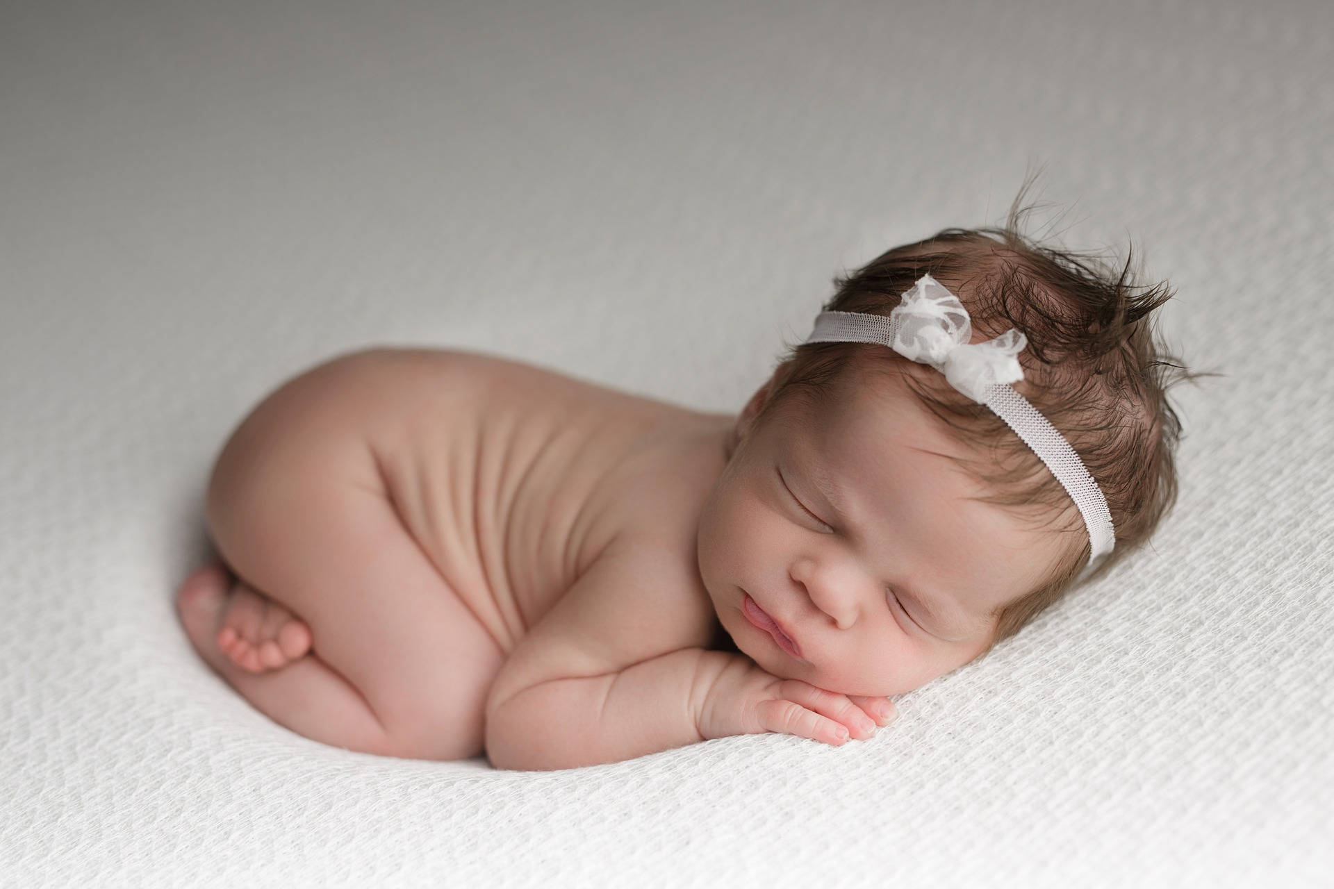 Very Cute Baby In Fetal Position Wallpaper