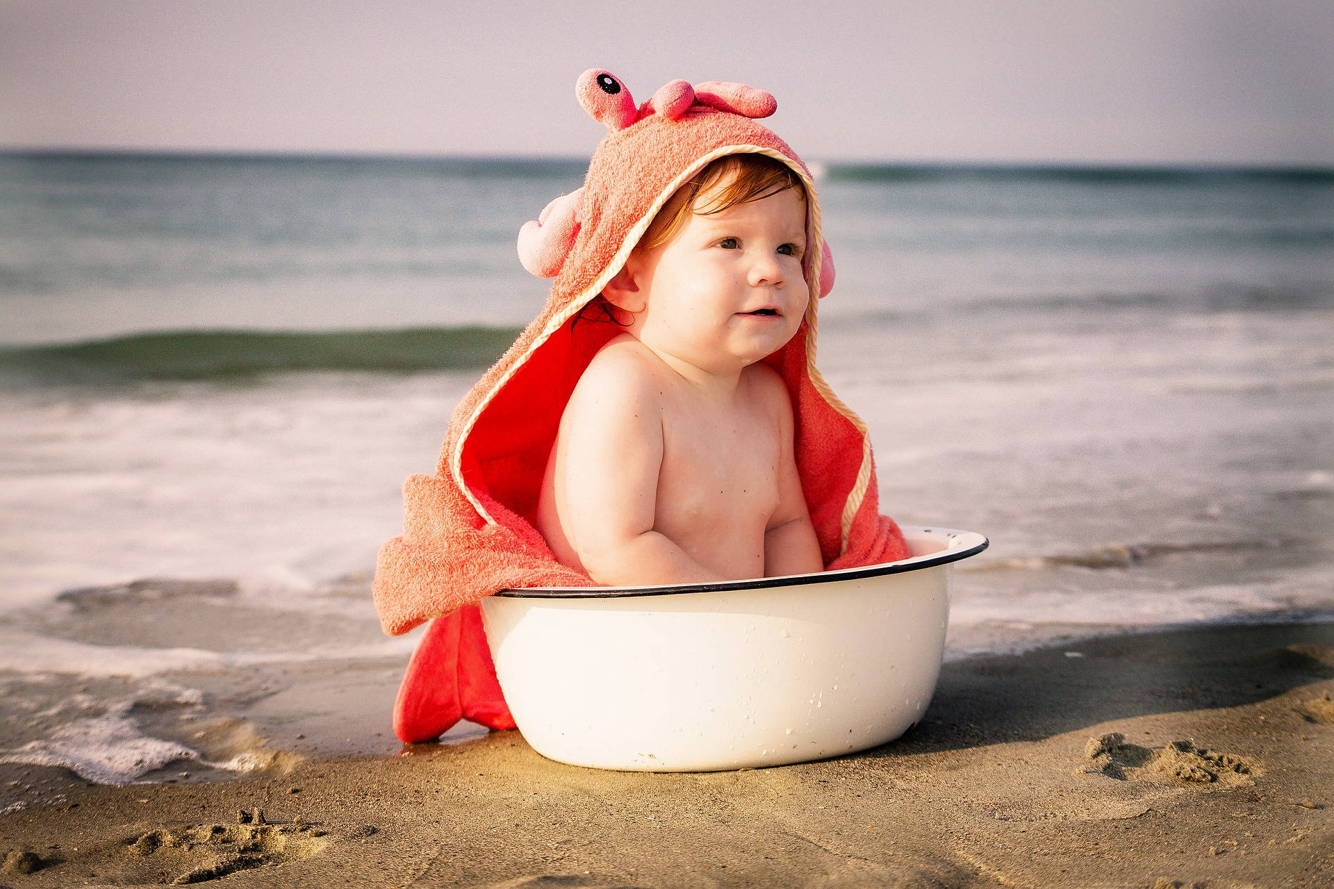 Very Cute Baby With Crab Towel Wallpaper