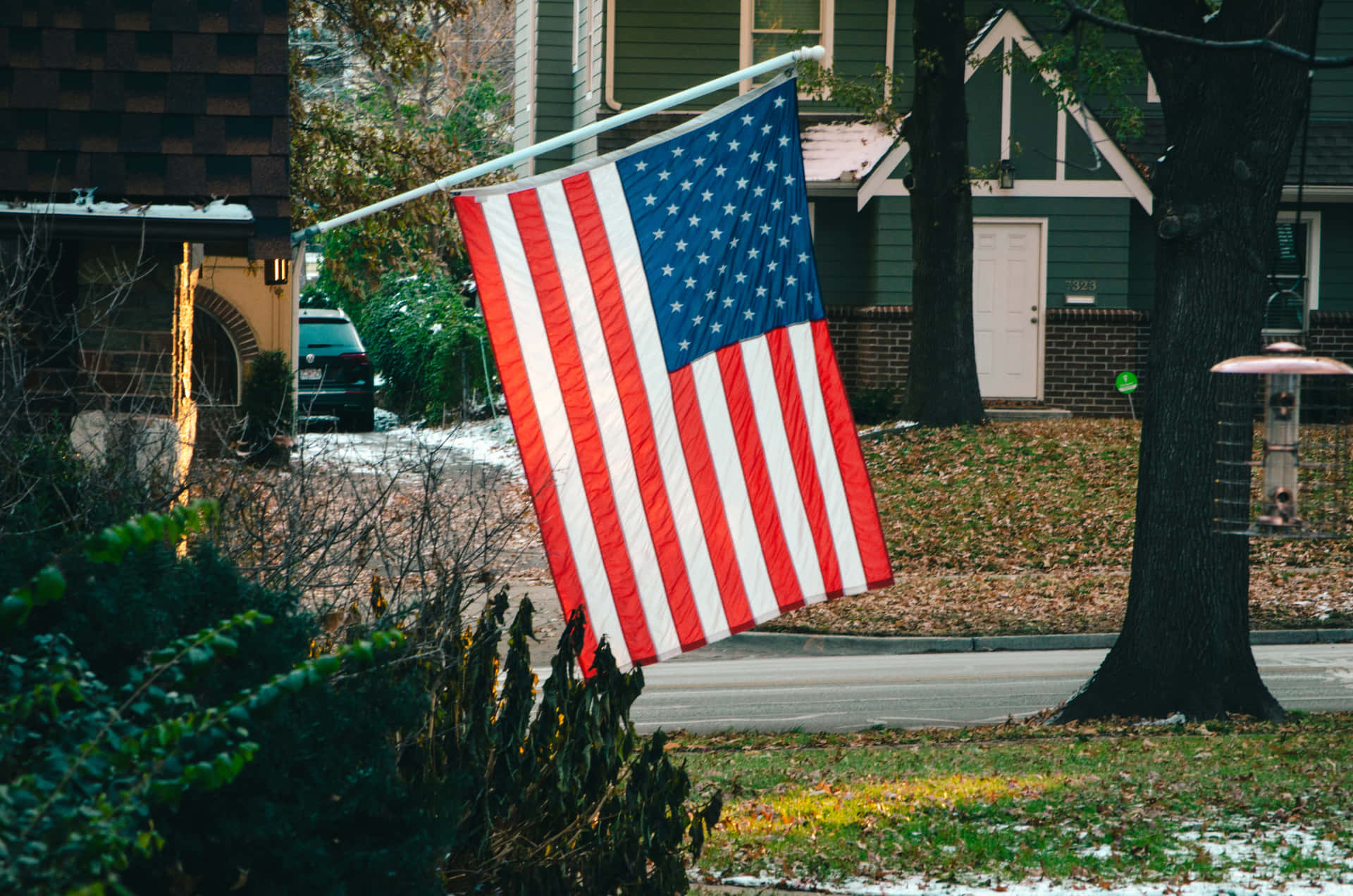 Vibrant American Flag Waving Against Blue Sky Wallpaper