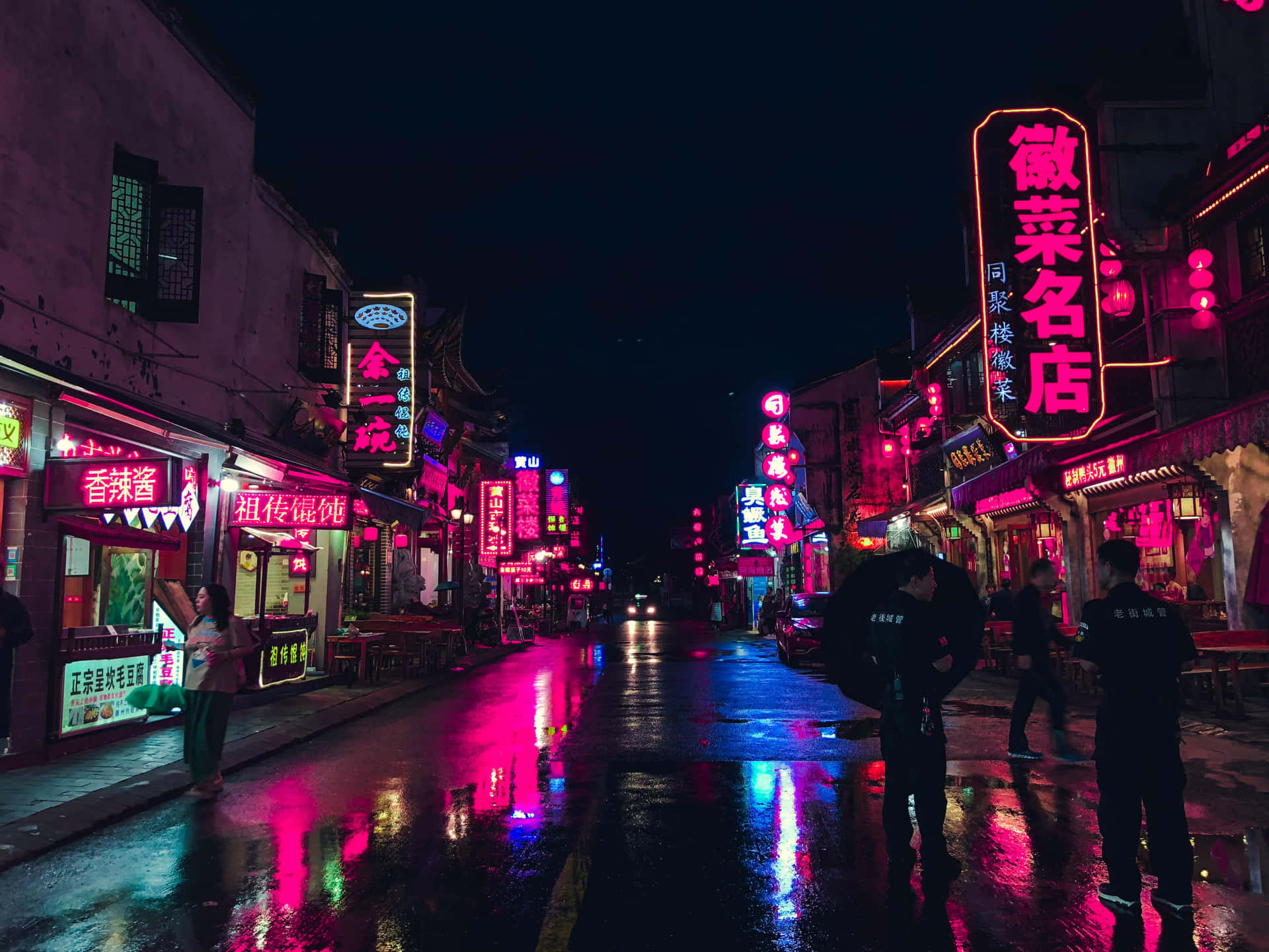 Vibrant Neon Street At Night Wallpaper