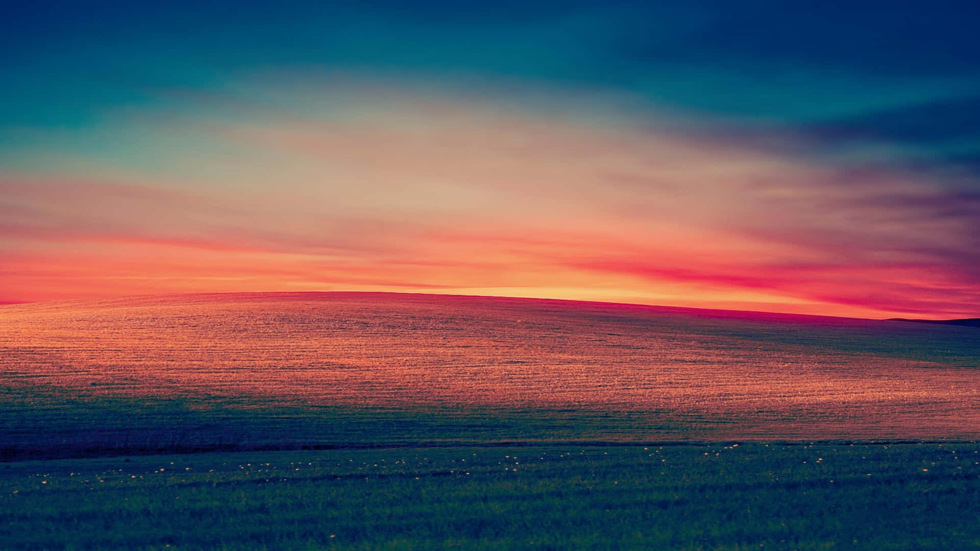 Vibrant Sunset Over Rolling Hills.jpg Wallpaper