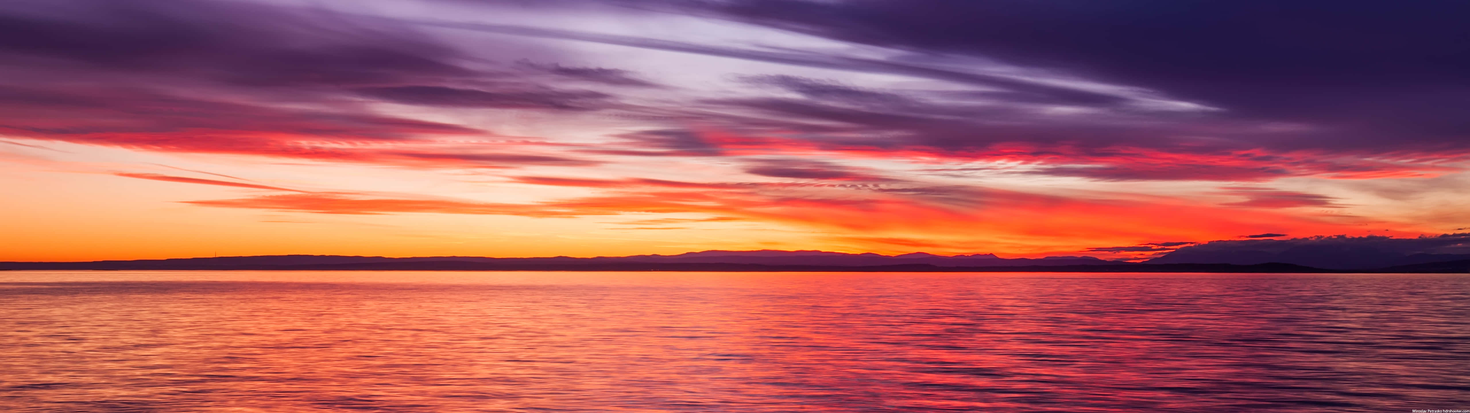 Vibrant_ Sunset_ Over_ Water_ Panorama Wallpaper