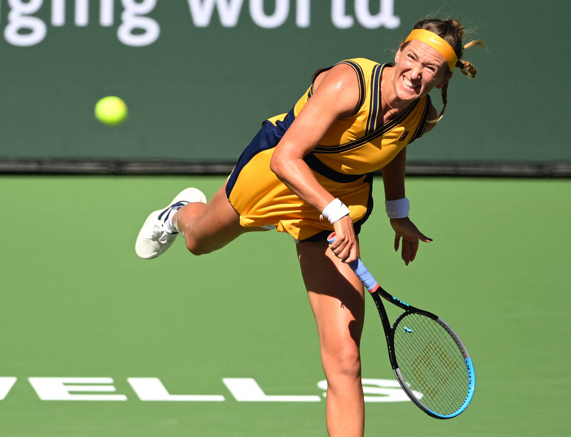 Victoria Azarenka Swinging Racket In Yellow Wallpaper
