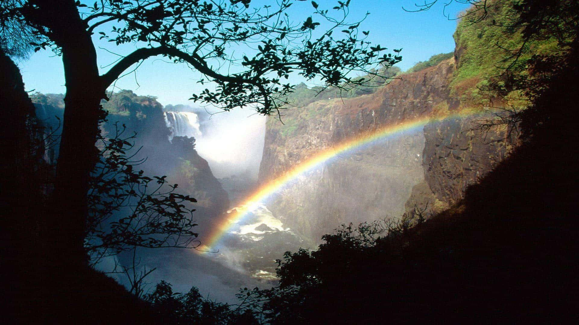 Victoria Falls With A Shining Rainbow Wallpaper