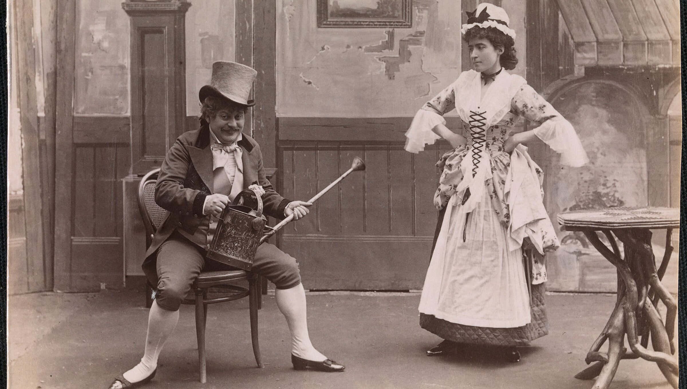 A Man And Woman In A Costume Playing A Musical Instrument