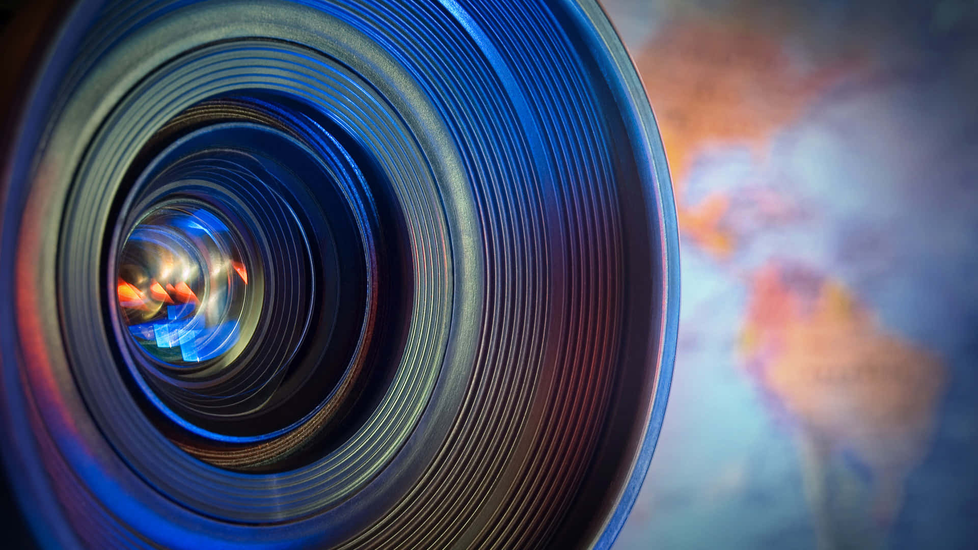 close up of a camera lens with a world map Wallpaper