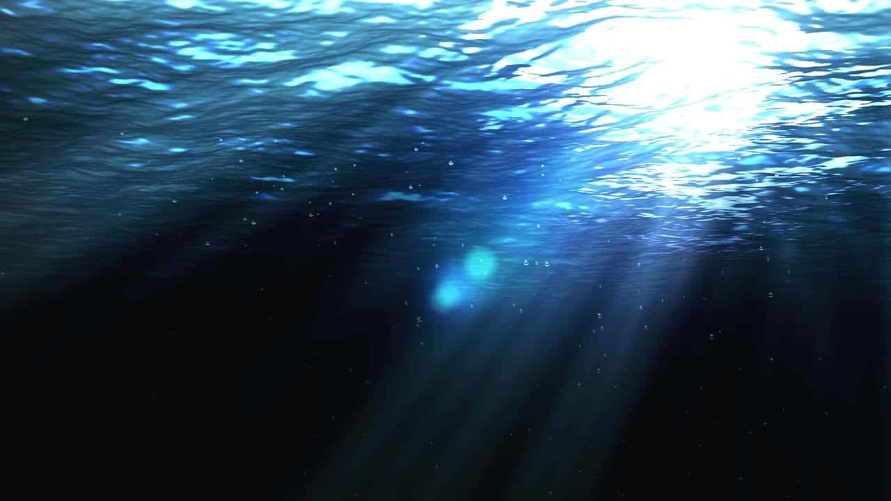 underwater light shining through the water Wallpaper