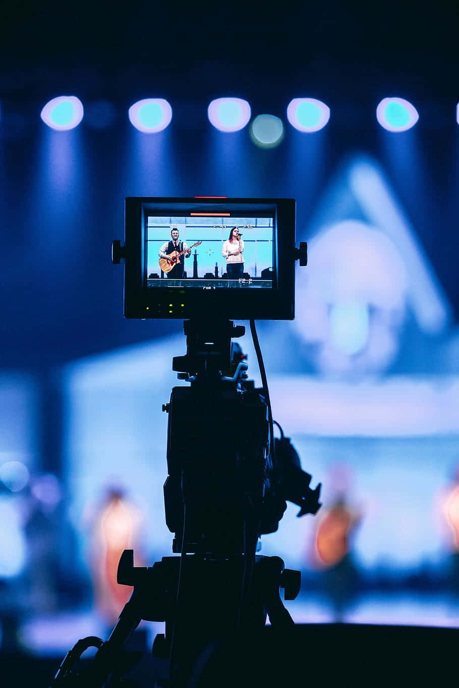 A Video Camera Is In Front Of A Stage Wallpaper