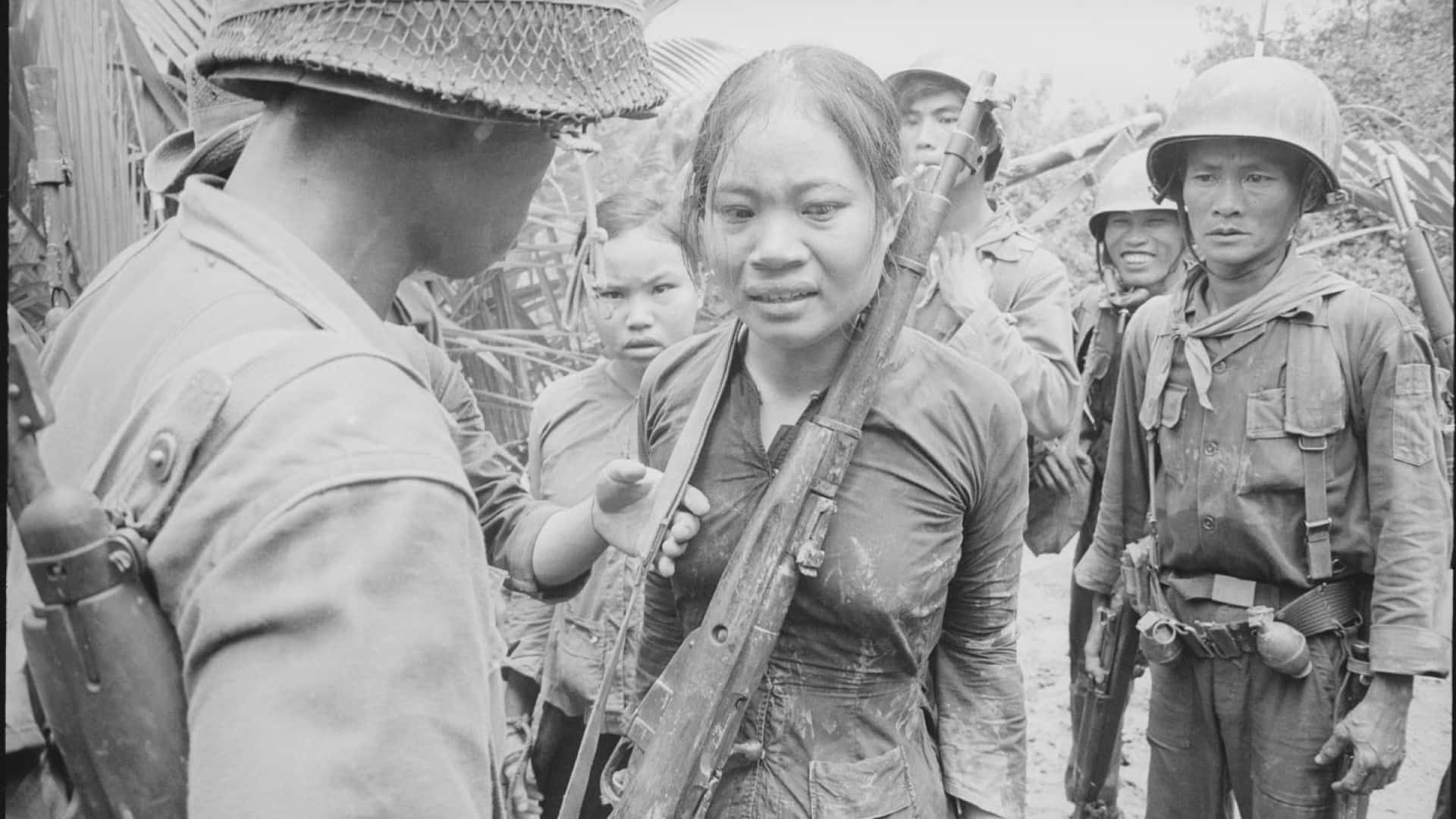 A Woman Is Talking To Soldiers In A Black And White Photo