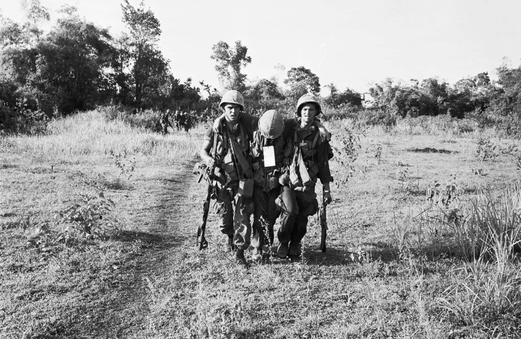 Two Soldiers Walking Down A Dirt Path