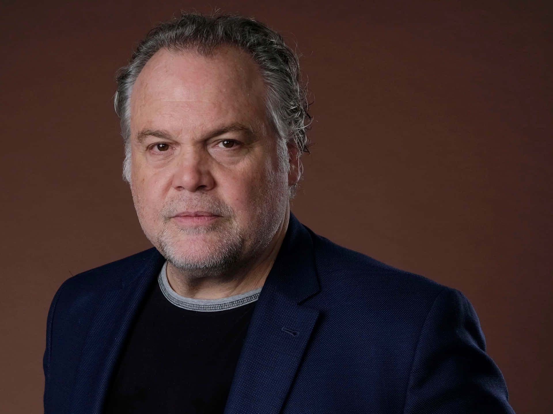 Vincent D'Onofrio strikes an intense pose in a dark suit Wallpaper