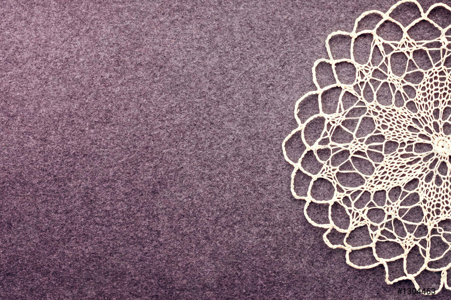 a white doily on a purple background
