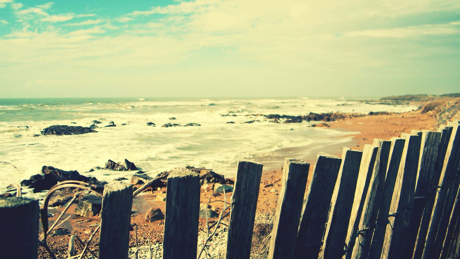 Vintage Beach Scenewith Weathered Fence Wallpaper