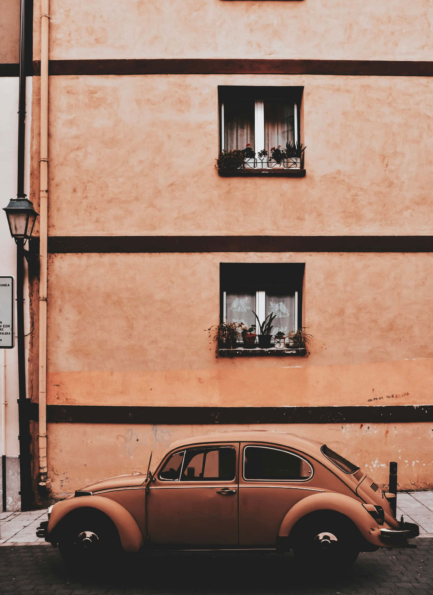 Vintage Beetle Outside Classic Building Wallpaper